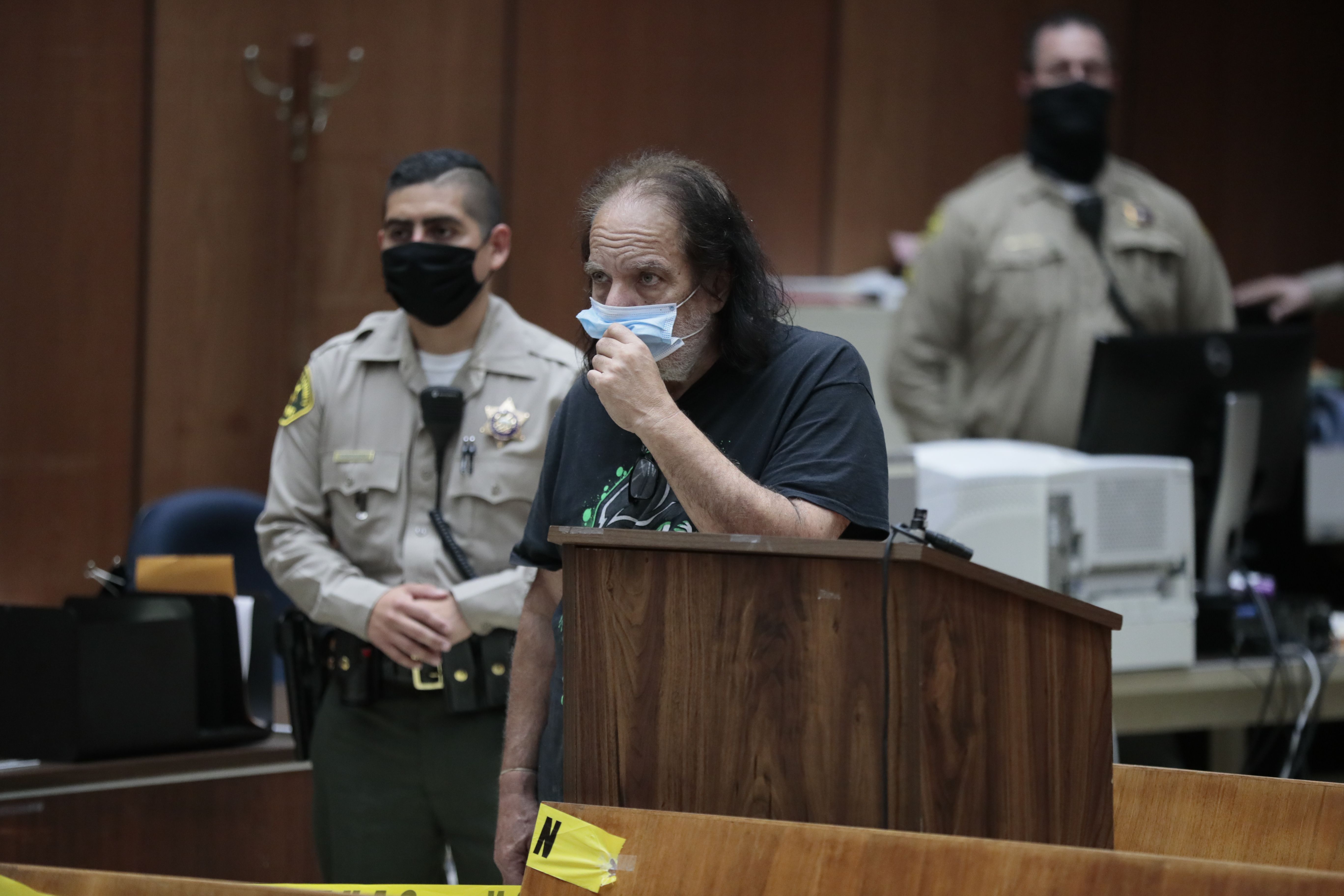 Adult film star Ron Jeremy (C) makes his first appearance in downtown Los Angeles Criminal Court, June 23, 2020. - Adult film star Ron Jeremy has been charged with raping three women and sexually assaulting a fourth, Los Angeles prosecutors said Tuesday. (Photo by ROBERT GAUTHIER/POOL/AFP via Getty Images)