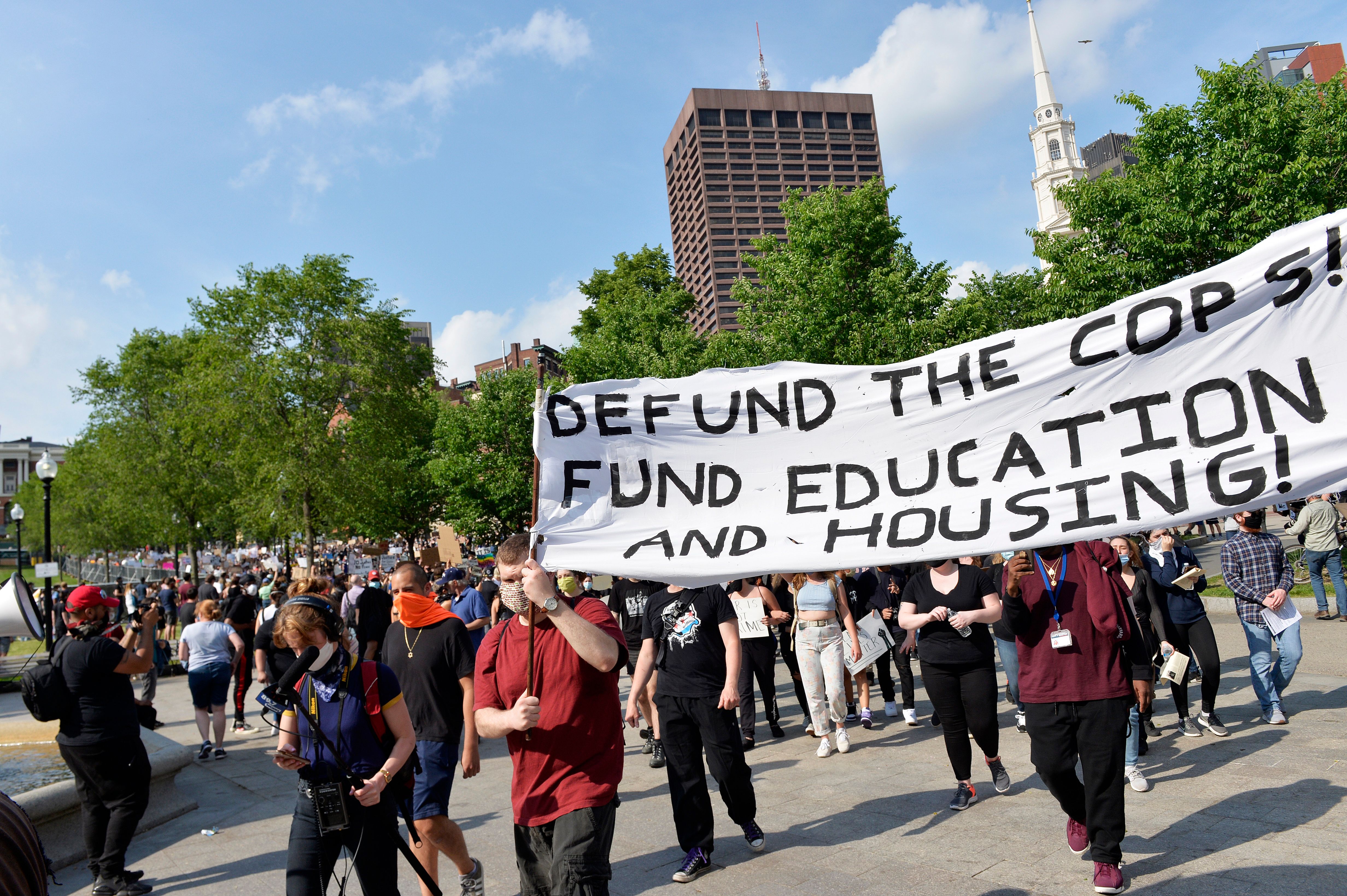 People hold up placards and their arms as they march during a "Black Lives Matter" rally, in response to the death of George Floyd and other victims of Police Racism across the US, at Boston Common, in Boston, Massachusetts on June 3, 2020. - Anti-racism protests have put several US cities under curfew to suppress rioting, following the death of George Floyd while in police custody. (Photo by Joseph Prezioso / AFP) (Photo by JOSEPH PREZIOSO/AFP via Getty Images)