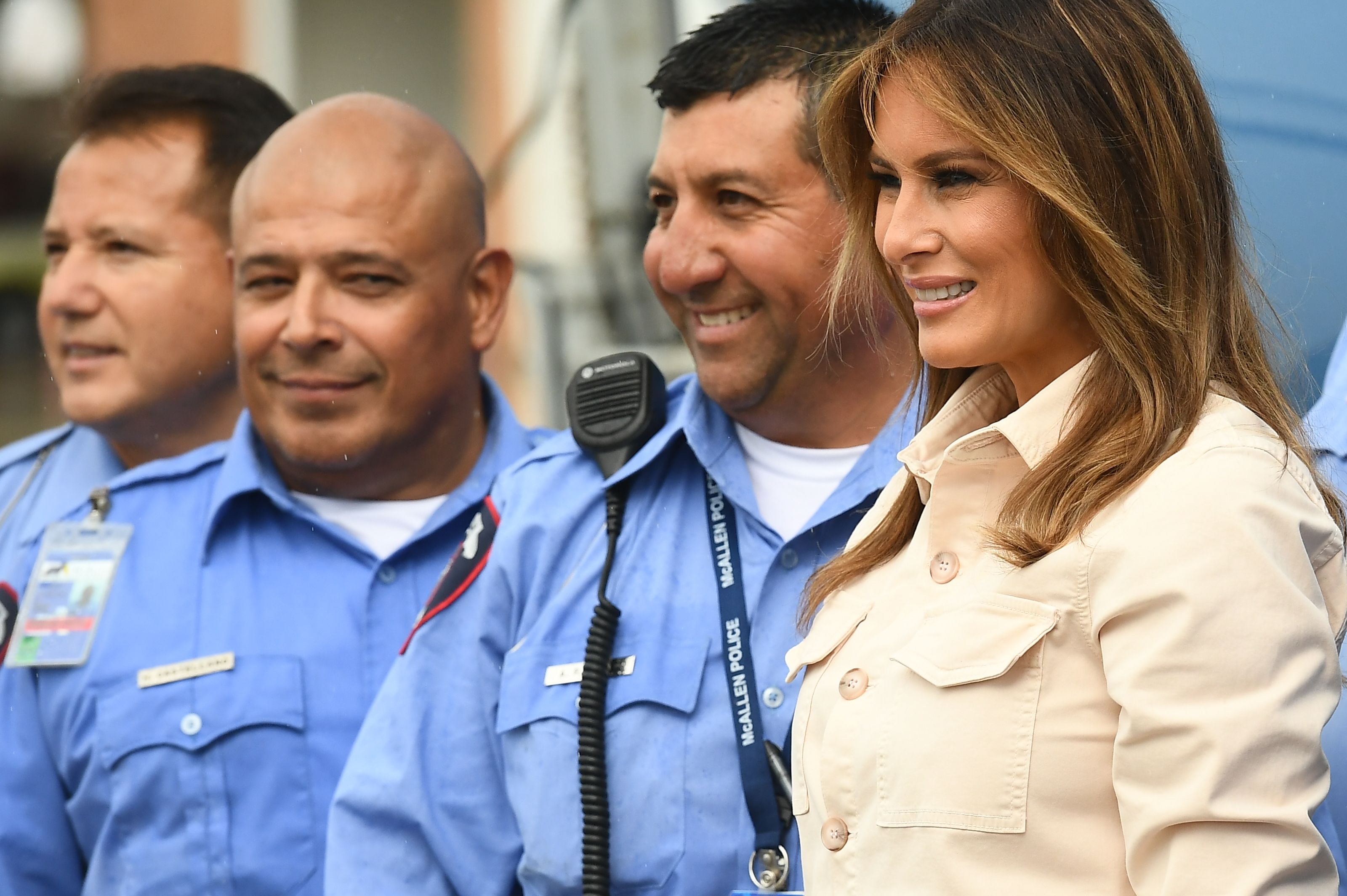 US First Lady Melania Trump poses with McAllen city police during a visit to the Luthern Social Services of the South's Upbring New Hope Children Center in McAllen, Texas on June 21, 2018. - First Lady Melania Trump made a surprise visit to the US-Mexican border on Thursday, June 21, 2018 as her husband's administration seeks to quell a firestorm over migrant family separations. President Donald Trump first announced the trip by his wife, who will tour a non-profit social services center for migrant children, as well as a customs and border patrol processing center, according to a statement from her office. (Photo by MANDEL NGAN / AFP) (Photo credit should read MANDEL NGAN/AFP via Getty Images)