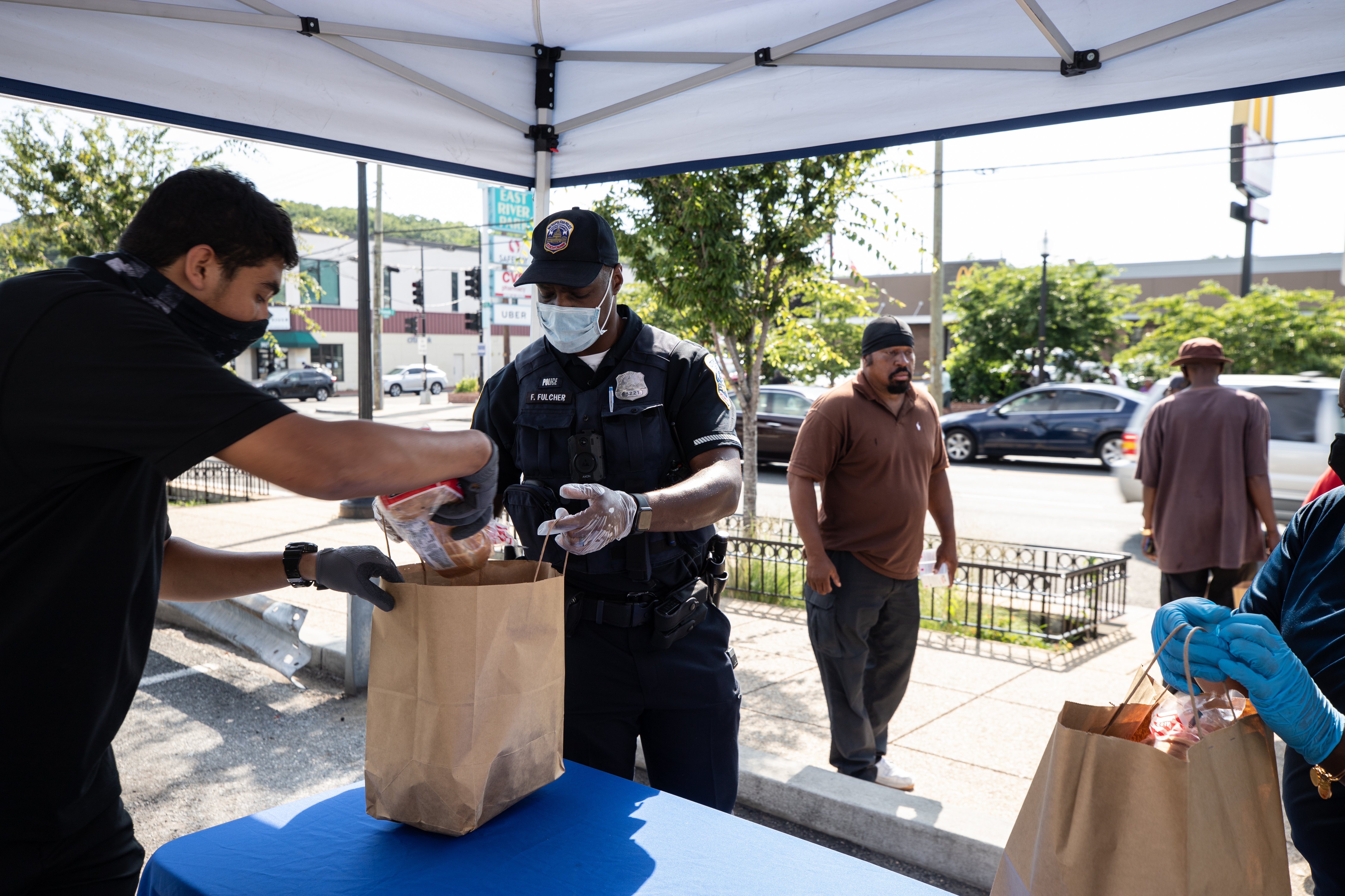 D.C. Metro Police Officers pass out grocery bags to people in D.C.'s Sixth District. (Photo: Kaylee C. Greenlee - Daily Caller News Foundation)