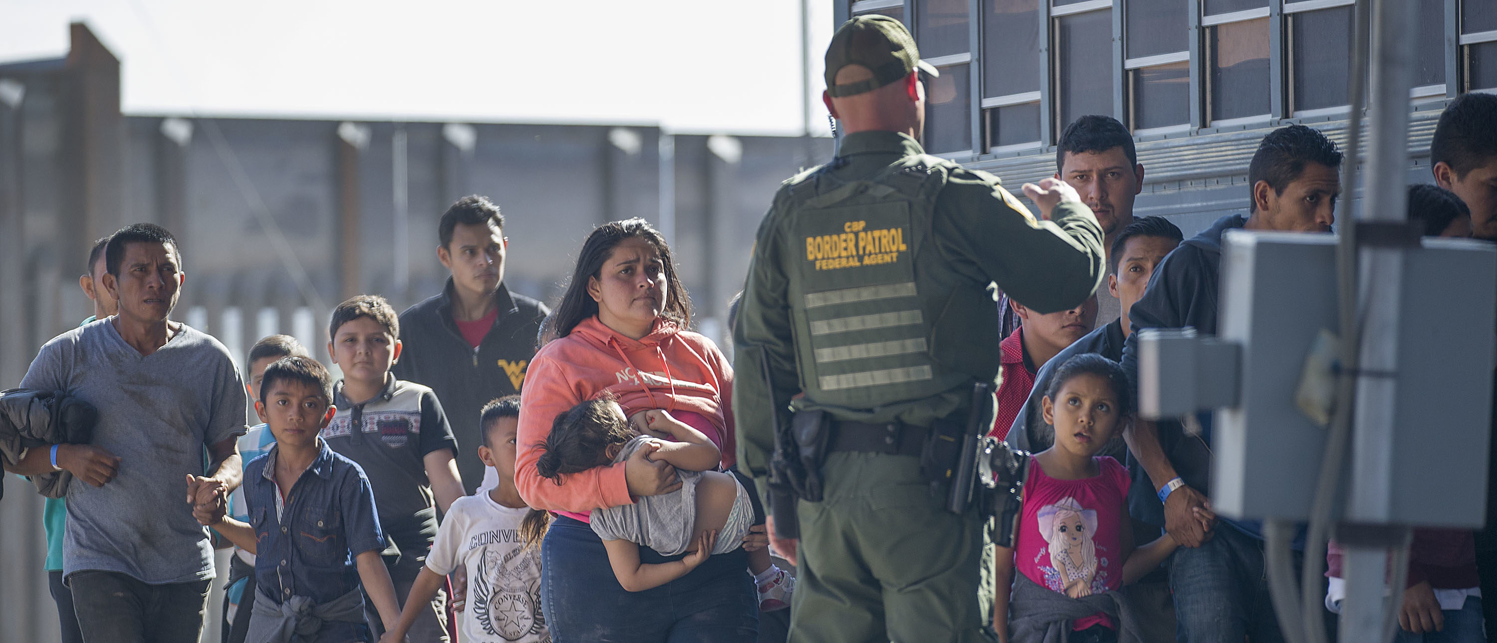 EL PASO, TEXAS - JUNE 01: Migrants are loaded onto a bus by U.S. Border Patrol agents after being detained when they crossed into the United States from Mexico on June 01, 2019 in El Paso, Texas. The location is in an area where migrants frequently turn themselves in to Border Patrol and ask for asylum after crossing the border. In recent months, U.S. immigration officials have seen a surge in the number of asylum seekers arriving at the border. (Photo by Joe Raedle/Getty Images)