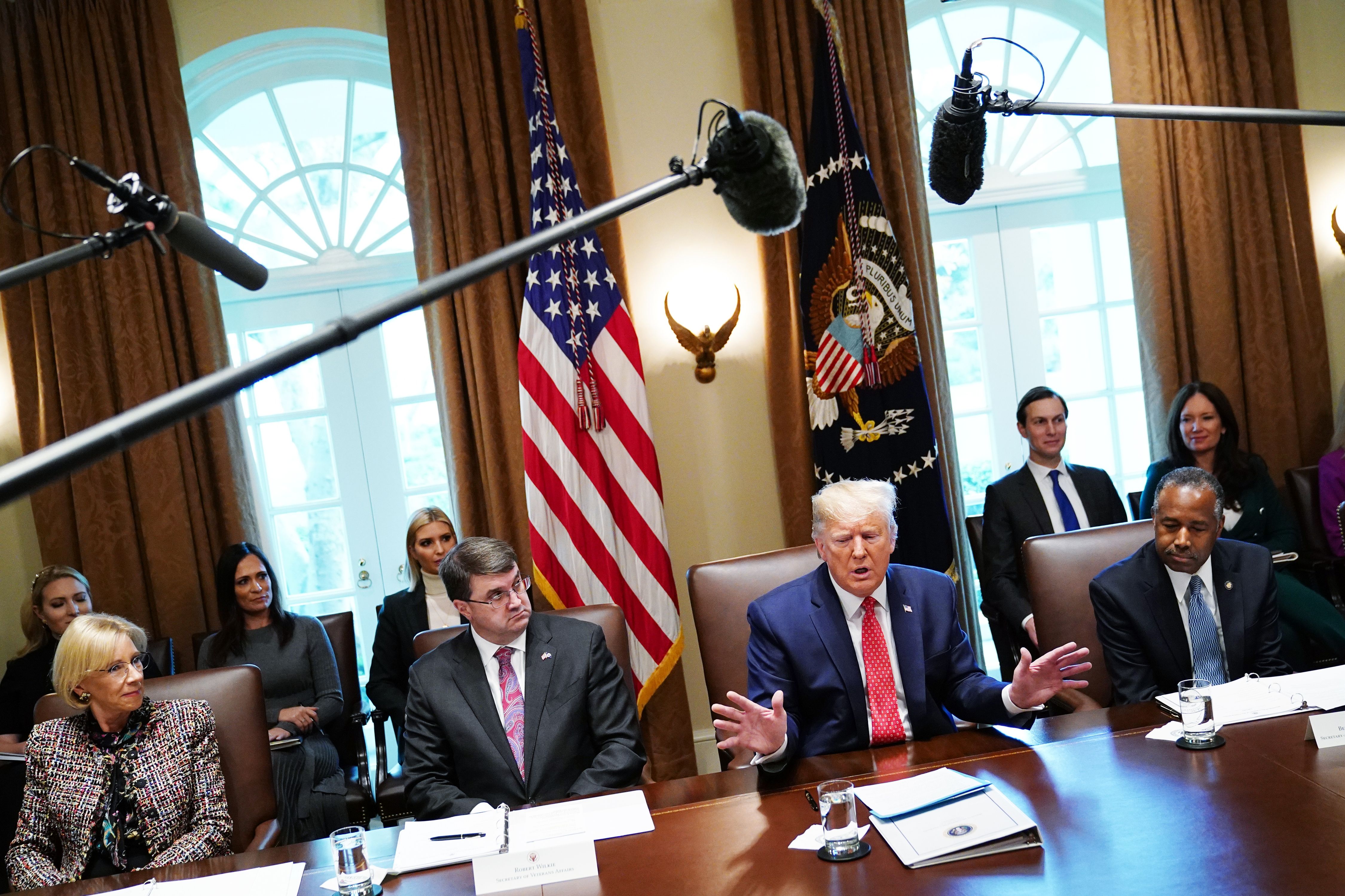 US President Donald Trump speak during a cabinet meeting in the Cabinet Room of the White House in Washington, DC on November 19, 2019, as (L-R) Education Secretary Betsy DeVos, Veterans Affairs Secretary Robert Wilkie, and Secretary of Housing and Urban Development Ben Carson listen. (Photo by MANDEL NGAN/AFP via Getty Images)