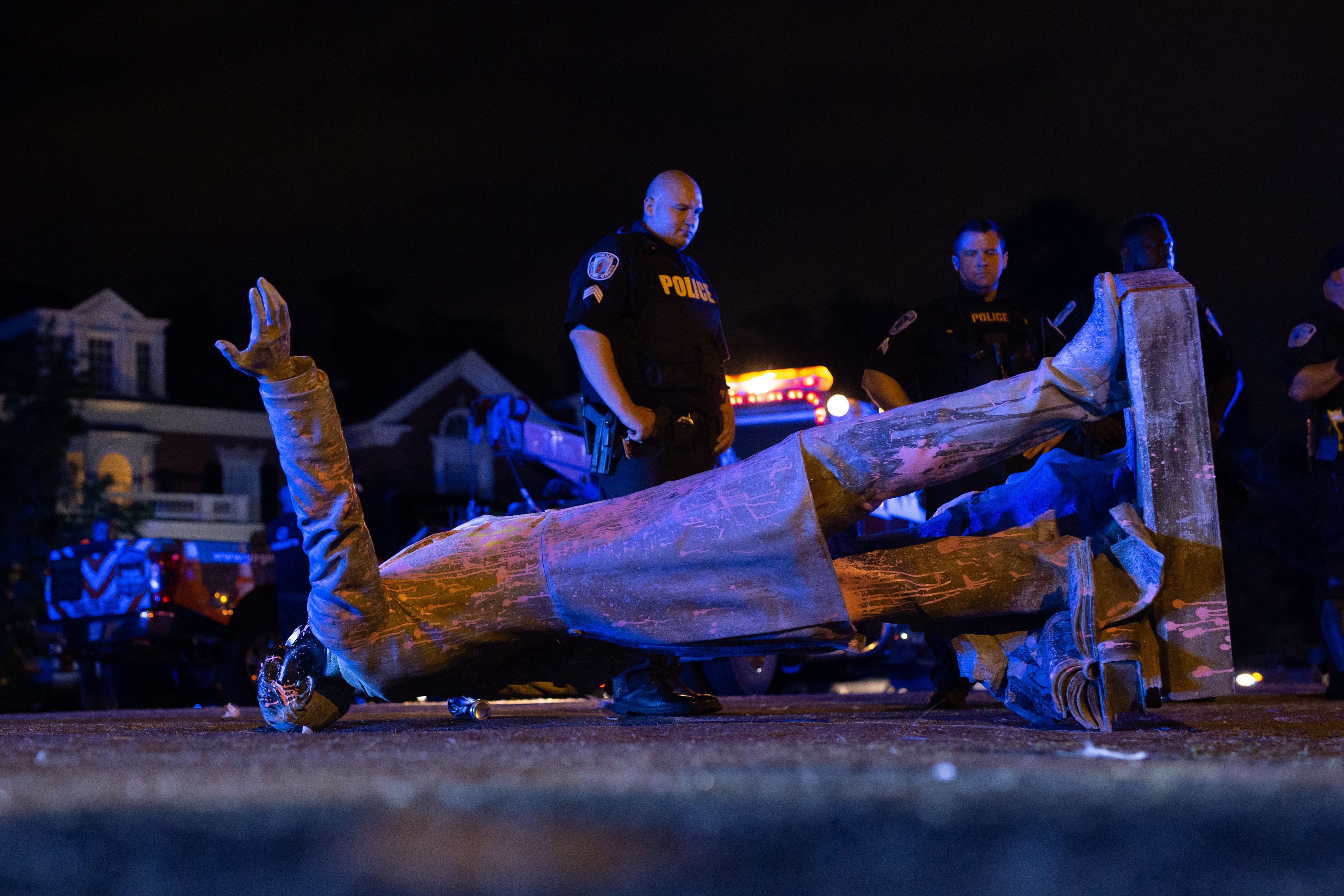 TOPSHOT - A statue of Confederate States President Jefferson Davis lies on the street after protesters pulled it down in Richmond, Virginia, on June 10, 2020. - The symbols of the Confederate States and its support for slavery are being targeted for removal following the May 25, 2020, death of George Floyd while in police custody. (Photo by Parker Michels-Boyce / AFP) (Photo by PARKER MICHELS-BOYCE/AFP via Getty Images)