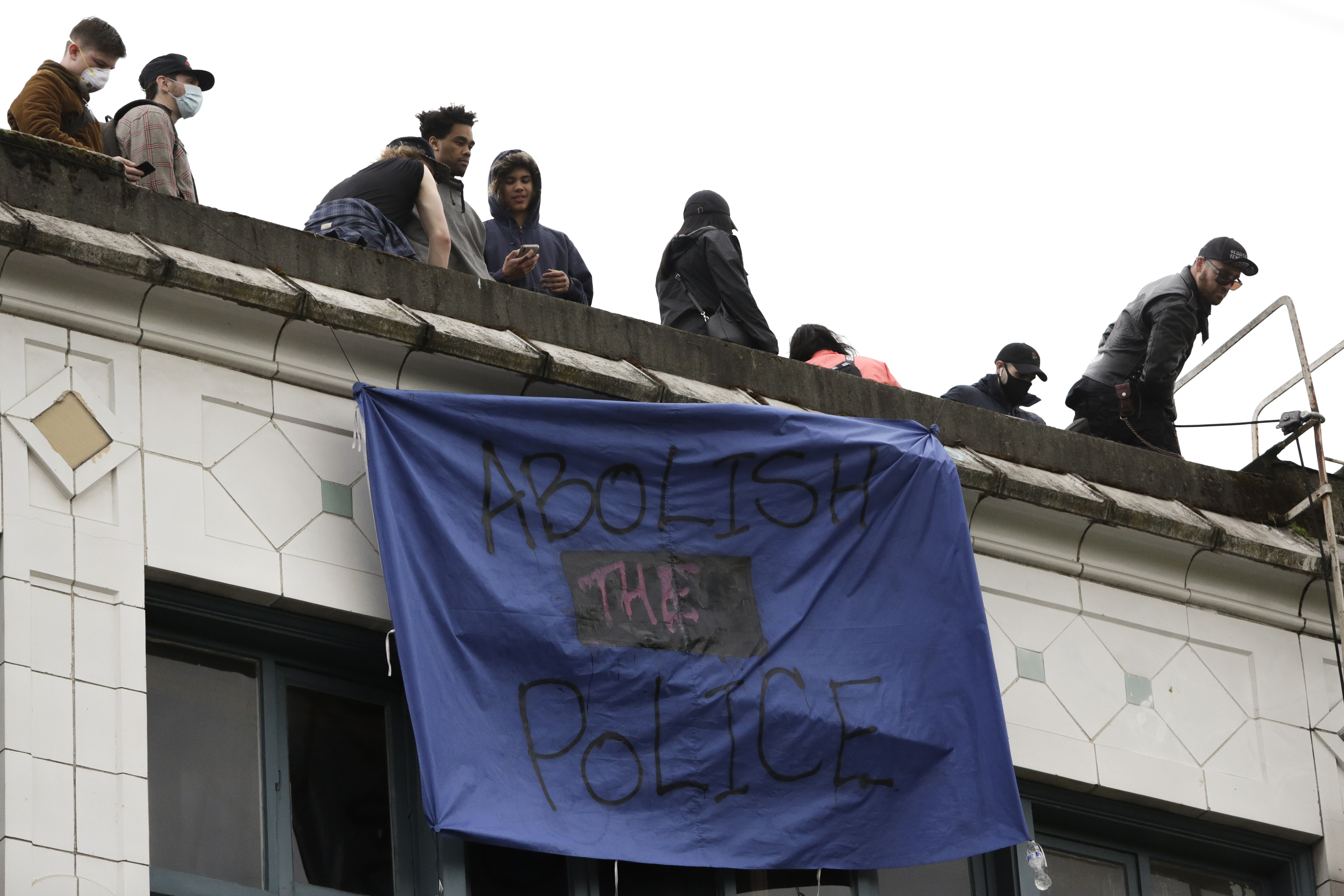A banner which reads "abolish the police" hangs from a building on June 12, 2020 in an area formerly known as the Capitol Hill Autonomous Zone located in Seattle. (Photo: Jason Redmond/AFP via Getty Images)