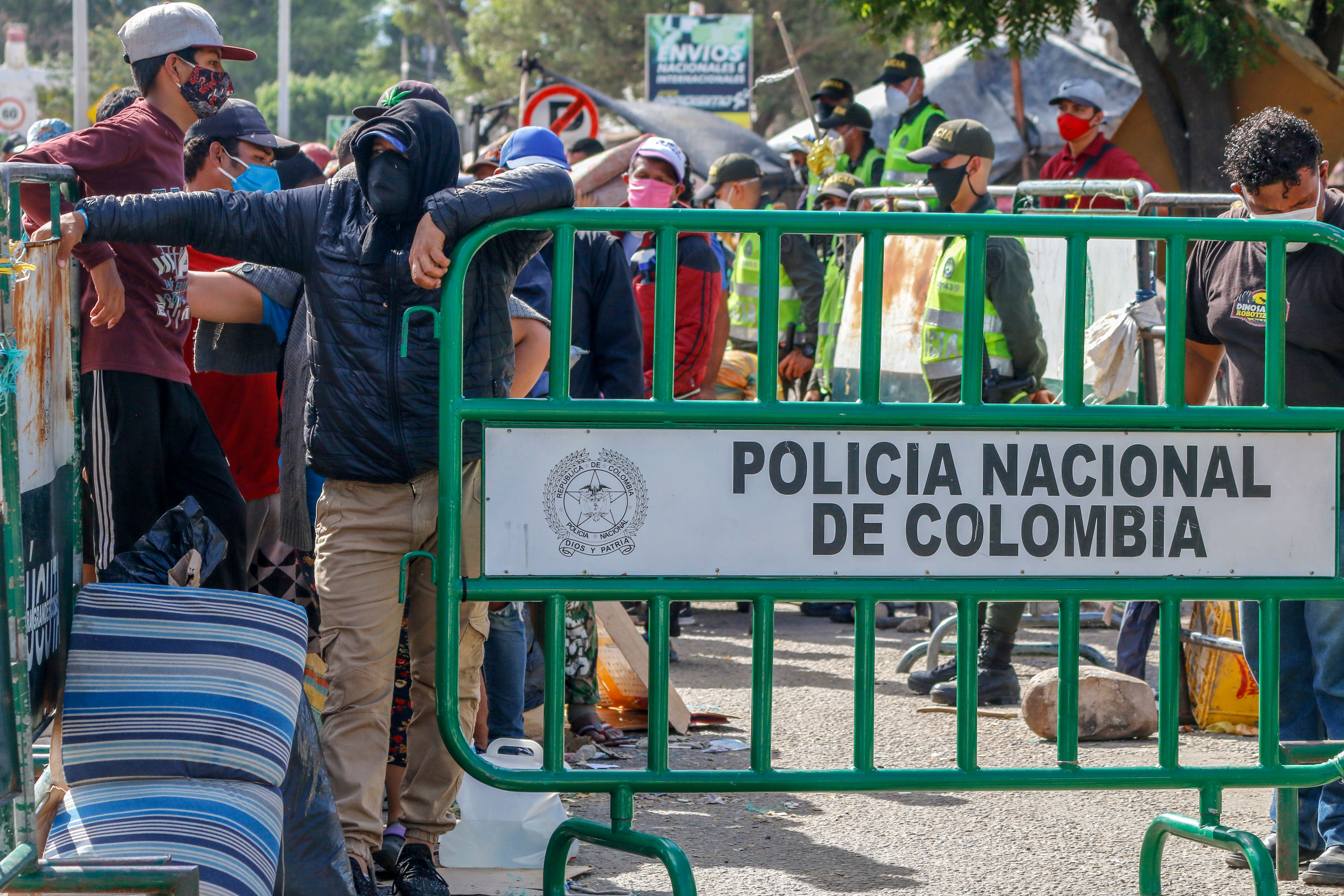 Venezuelans queue as they are being transferred from the Simon Bolivar international crossing point to the Tienditas International Bridge where they will be housed in tents, in Cucuta, Colombia, on the border with Venezuela, on June 14, 2020. - Hundreds of Venezuelans who fled to neighbouring Colombia during their country's economic crisis are now returning home, pushed by the deadly novel coronavirus and Colombia's own pandemic woes. Although the border is officially closed as a measure taken to halt the spread of coronavirus, Colombia opened a "humanitarian corridor". (SCHNEYDER MENDOZA/AFP via Getty Images)