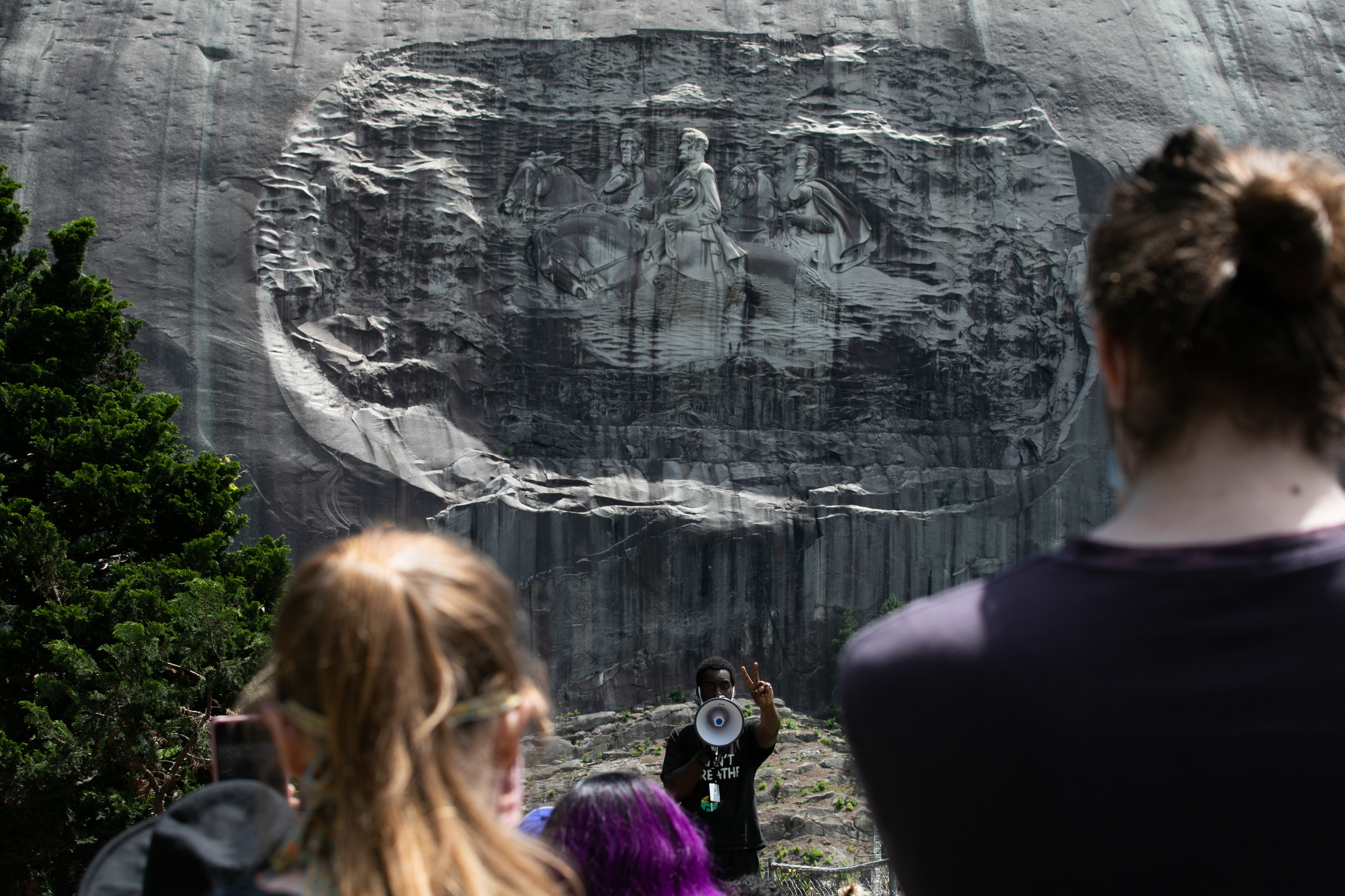 STONE MOUNTAIN, GA - JUNE 16: Organizer Quintavious Rhodes addresses Black Lives Matter protesters during a march in Stone Mountain Park to the Confederate carving etched into the stone side of the mountain on June 16, 2020 in Stone Mountain, Georgia. The march is to protest confederate monuments and recent police shootings. Stone Mountain Park features a Confederate Memorial carving depicting Stonewall Jackson and Robert E. Lee, President Jefferson Davis. (Photo by Jessica McGowan/Getty Images)