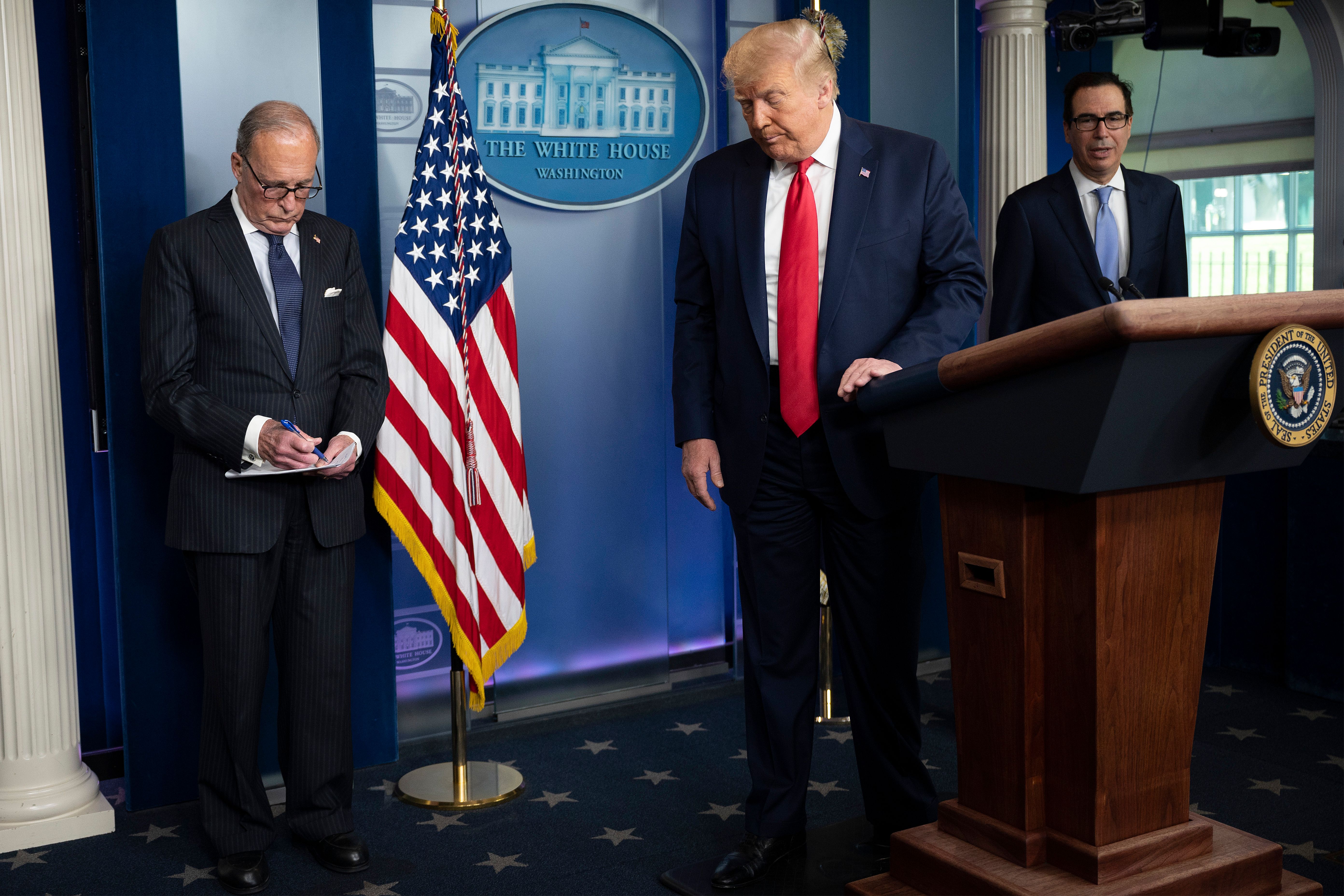 US President Donald Trump, with Director of the National Economic Council Larry Kudlow (L) and US Secretary of the Treasury Steven Mnuchin, leaves after speaking to the press in the Brady Briefing Room of the White House in Washington, DC, on July 2, 2020. - Trump on Thursday hailed the "spectacular" US jobs report for June, saying the return to work of 4.8 million Americans marks a huge comeback for an economy hit hard by the coronavirus pandemic. (Photo by JIM WATSON/AFP via Getty Images)