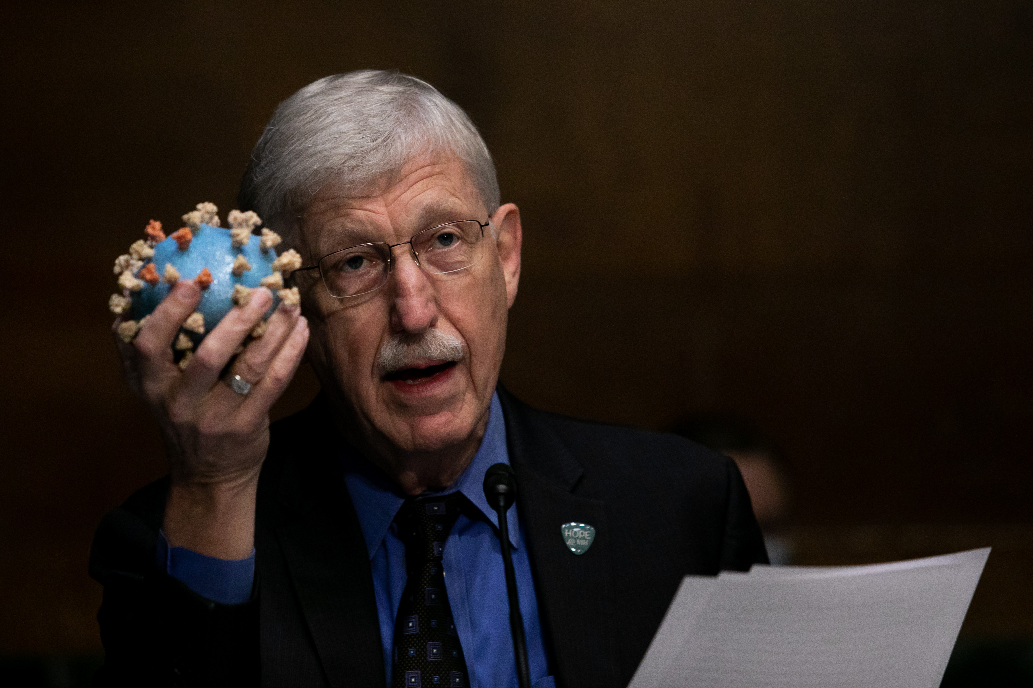 National Health Institute Director Francis S. Collins holds a model of a Coronavirus, as he testifies at a Senate hearing July 2, 2020 in Washington, DC. (Photo: Graeme Jennings-Pool/Getty Images)