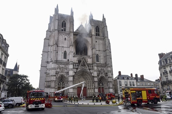 Firefighters are at work to put out a fire at the Saint-Pierre-et-Saint-Paul cathedral in Nantes, western France, on July 18, 2020. - A blaze that broke inside the gothic cathedral of Nantes on July 18 has been contained, emergency officials said, adding that the damage was not comparable to last year's fire at Notre-Dame cathedral in Paris. (Photo by SEBASTIEN SALOM-GOMIS/AFP via Getty Images)