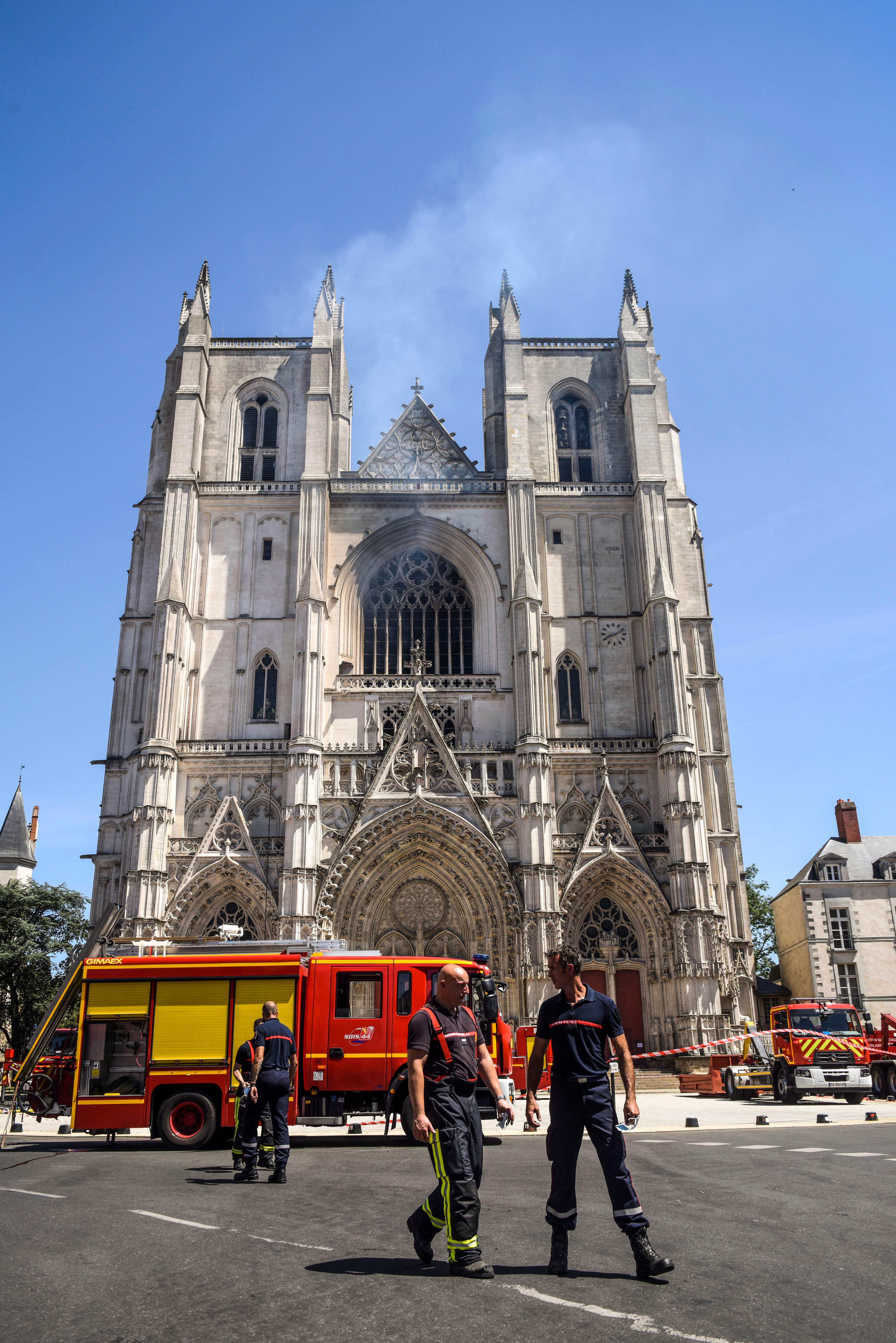 Firefighters are at work at the Cathedral of St Peter and St Paul in Nantes on July 18, 2020 after a fire ravaged parts of the gothic building before being brought under control, sparking an arson investigation and leaving Catholic officials lamenting the loss of priceless historical artefacts. (Photo by SEBASTIEN SALOM-GOMIS/AFP via Getty Images)