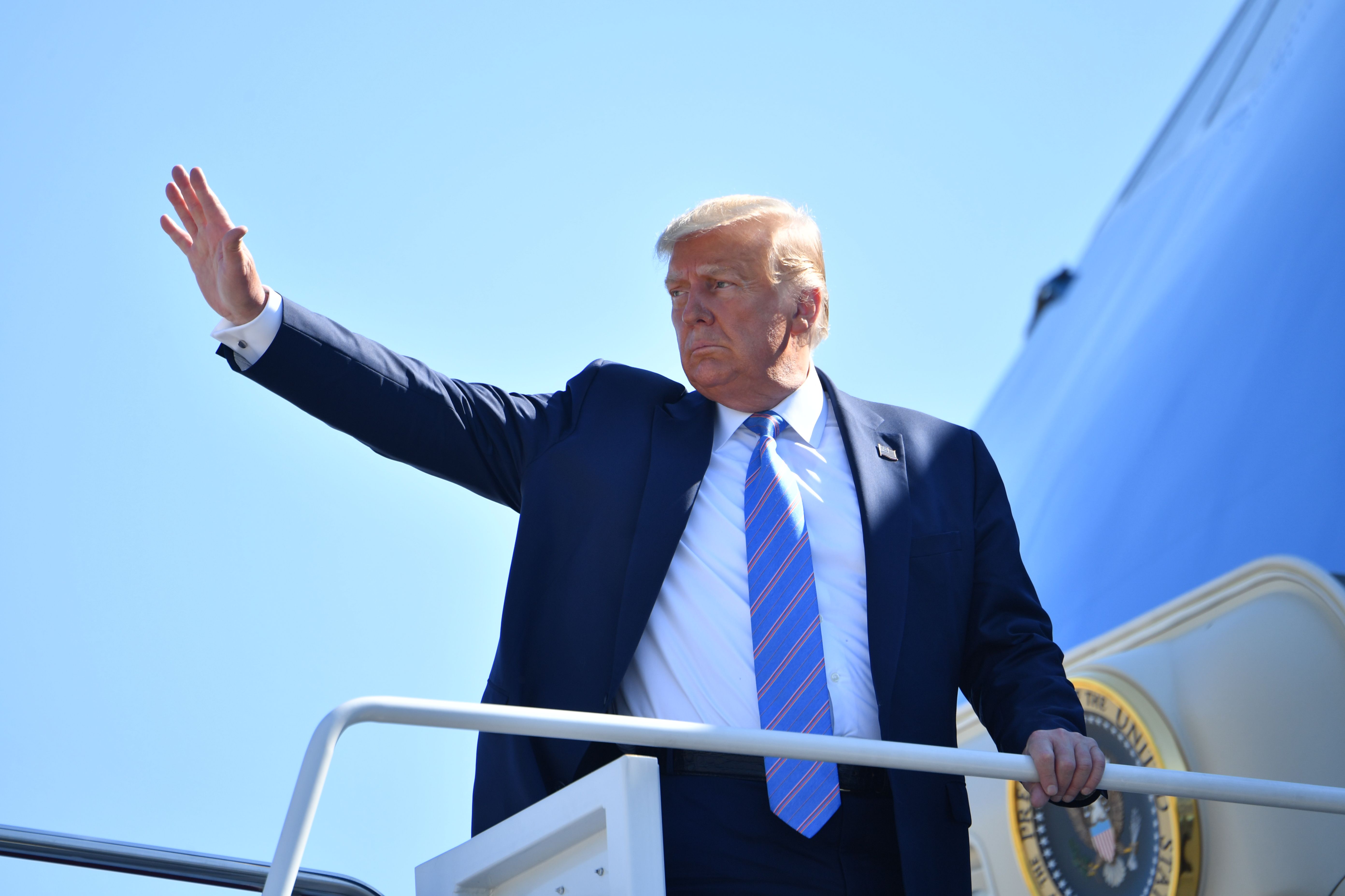 US President Donald Trump waves as he boards Air Force One on July 29, 2020 at Andrews Air Force Base, Maryland en route to Texas. (Photo by NICHOLAS KAMM/AFP via Getty Images)