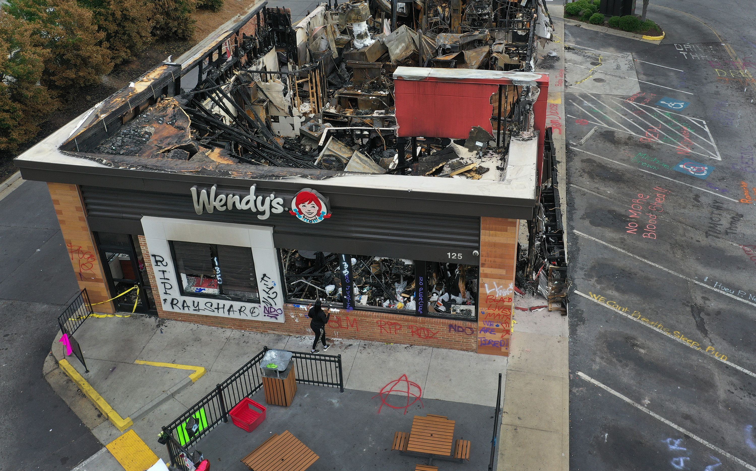 ATLANTA, GEORGIA - JUNE 17: In this aerial photo, the Wendy's restaurant that was set on fire by demonstrators after Rayshard Brooks was killed is seen on June 17, 2020 in Atlanta, Georgia. The site has become a place of remembrance for Mr. Brooks, who was killed by police while fleeing after a struggle during a field sobriety test in the Wendy's parking lot. (Photo by Joe Raedle/Getty Images)