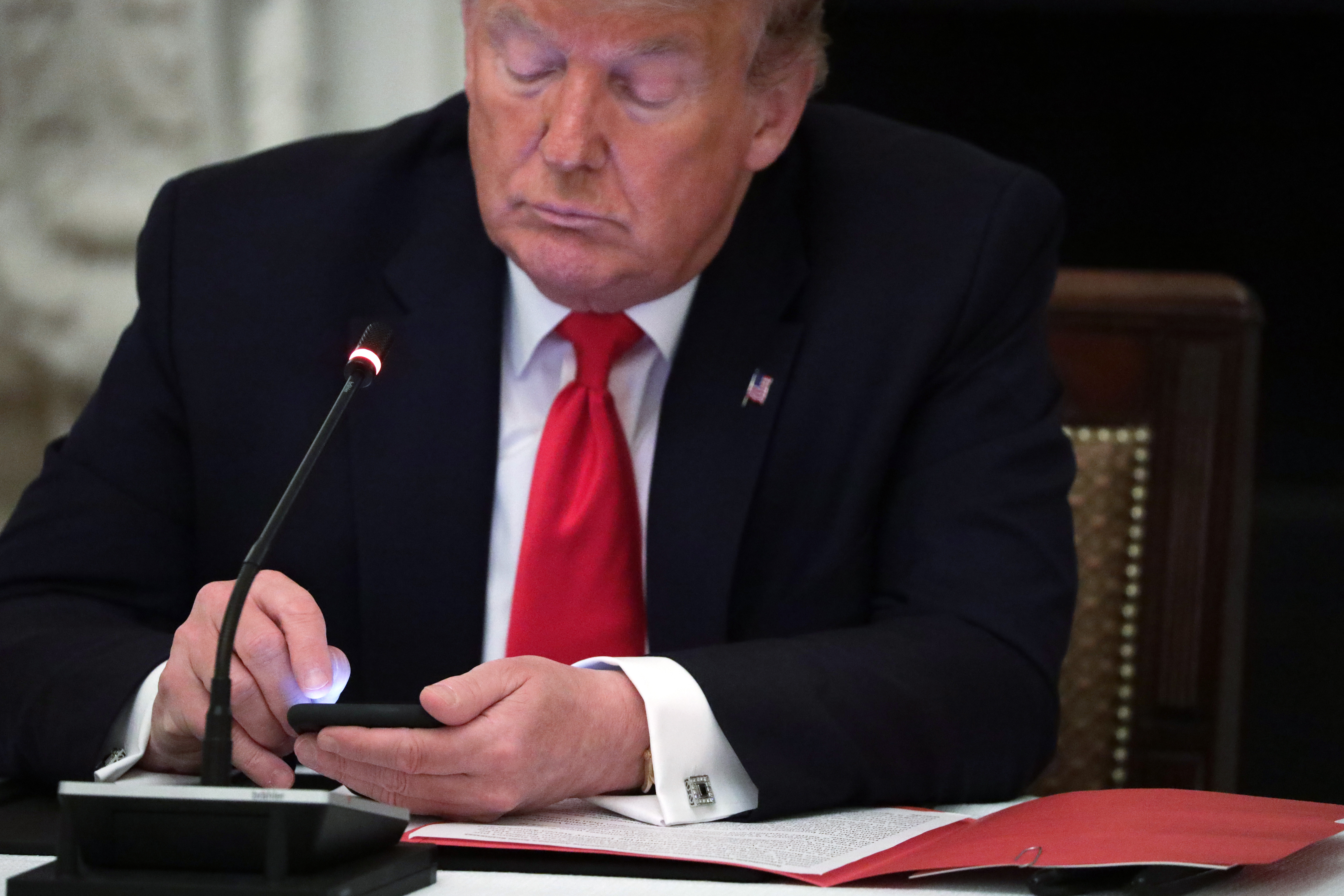 WASHINGTON, DC - JUNE 18: U.S. President Donald Trump works on his phone during a roundtable at the State Dining Room of the White House June 18, 2020 in Washington, DC. President Trump held a roundtable discussion with Governors and small business owners on the reopening of American’s small business. (Photo by Alex Wong/Getty Images)