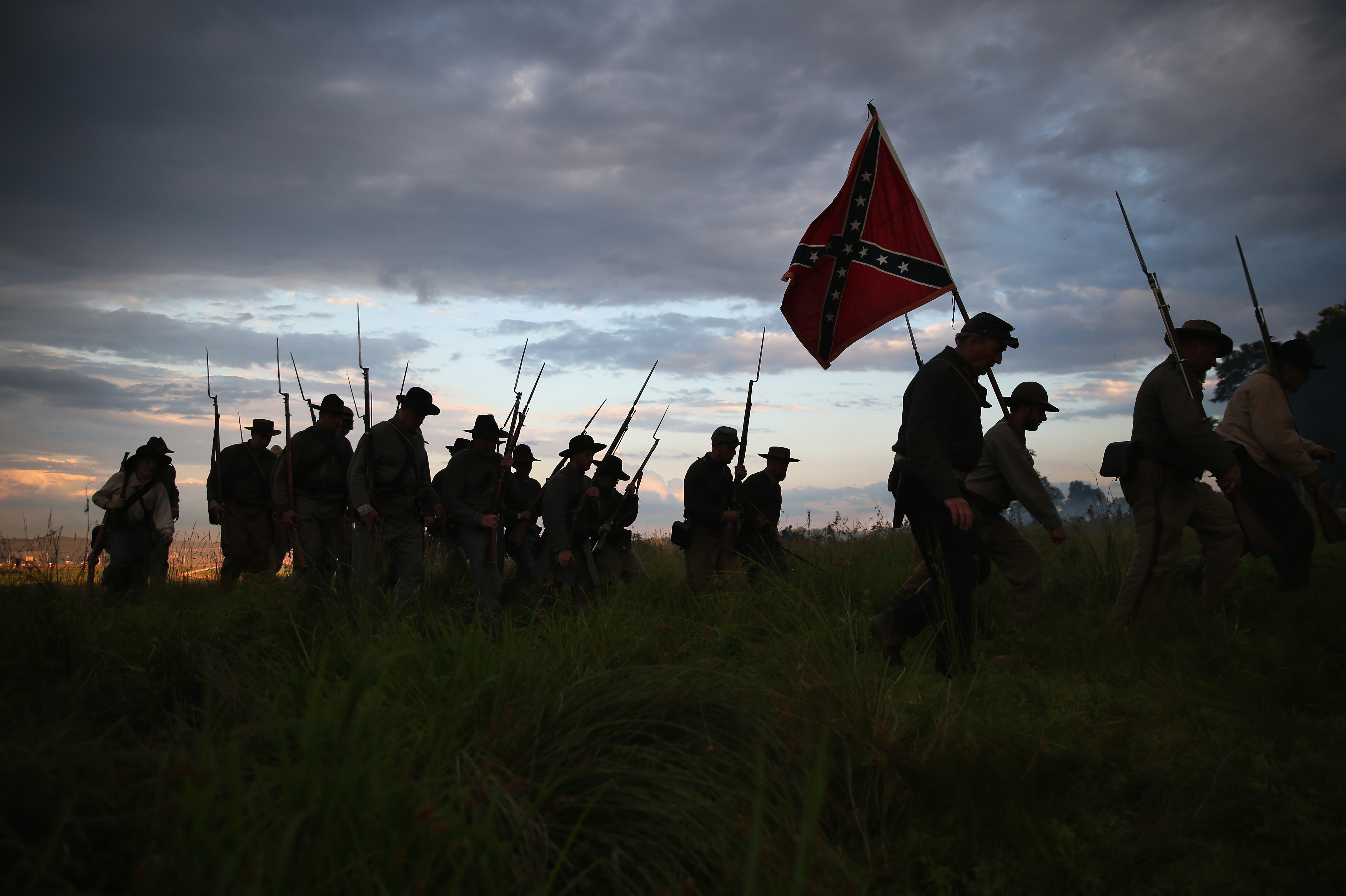 GETTYSBURG, PA - JUNE 29: Confederate Civil War re-enactors march for an evening attack during a three-day Battle of Gettysburg re-enactment on June 29, 2013 in Gettysburg, Pennsylvania. Some 8,000 re-enactors from the Blue Gray Alliance are participating in events marking the 150th anniversary of the July 1-3, 1863 Battle of Gettysburg, considered the turning point in the American Civil War. Union and Confederate armies suffered a combined total of some 46,000-51,000 casualties in the battle, the highest of any conflict of the war. (Photo by John Moore/Getty Images)