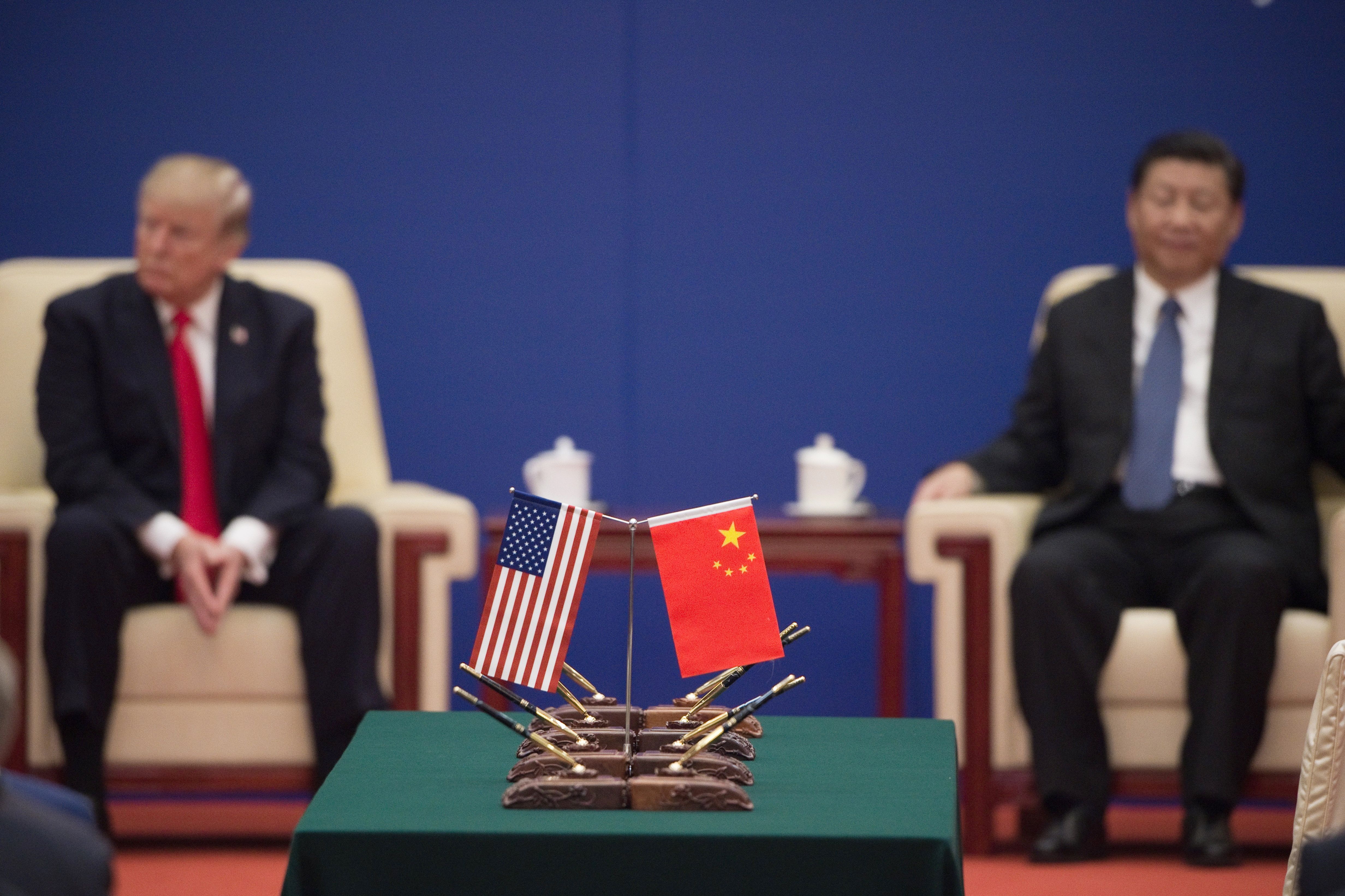 US President Donald Trump (L) and China's President Xi Jinping attend a business leaders event inside the Great Hall of the People in Beijing on November 9, 2017. Donald Trump urged Chinese leader Xi Jinping to work "hard" and act fast to help resolve the North Korean nuclear crisis, during their meeting in Beijing on November 9, warning that "time is quickly running out". / AFP PHOTO / Nicolas ASFOURI (Photo credit should read NICOLAS ASFOURI/AFP via Getty Images)