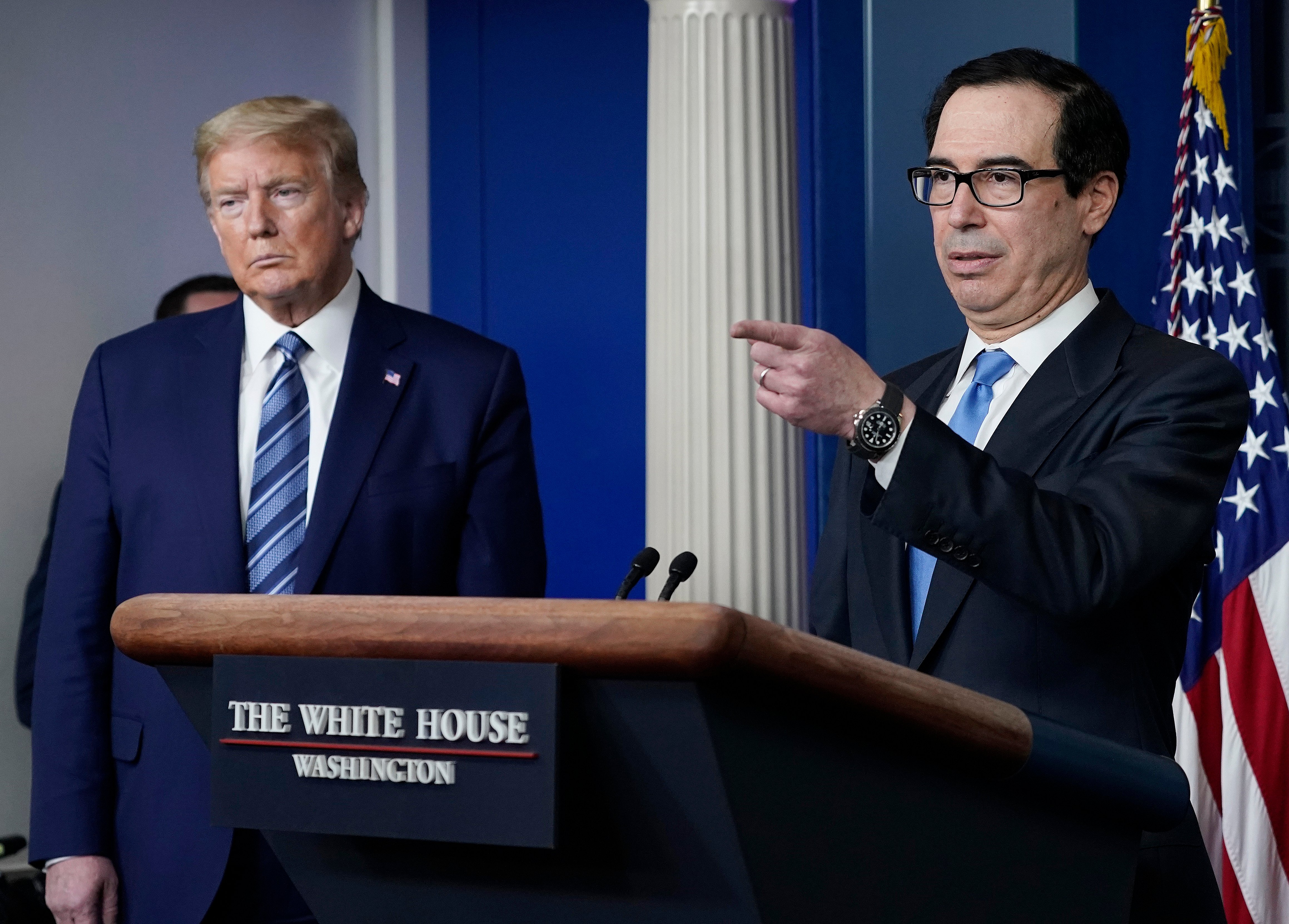 WASHINGTON, DC - APRIL 21: Treasury Secretary Steven Mnuchin speaks as U.S. President Donald Trump looks on during the daily coronavirus task force briefing at the White House on April 21, 2020 in Washington, DC. Earlier in the day, the president met with New York Gov. Andrew Cuomo in the Oval Office to discuss COVID-19 testing. (Photo by Drew Angerer/Getty Images)