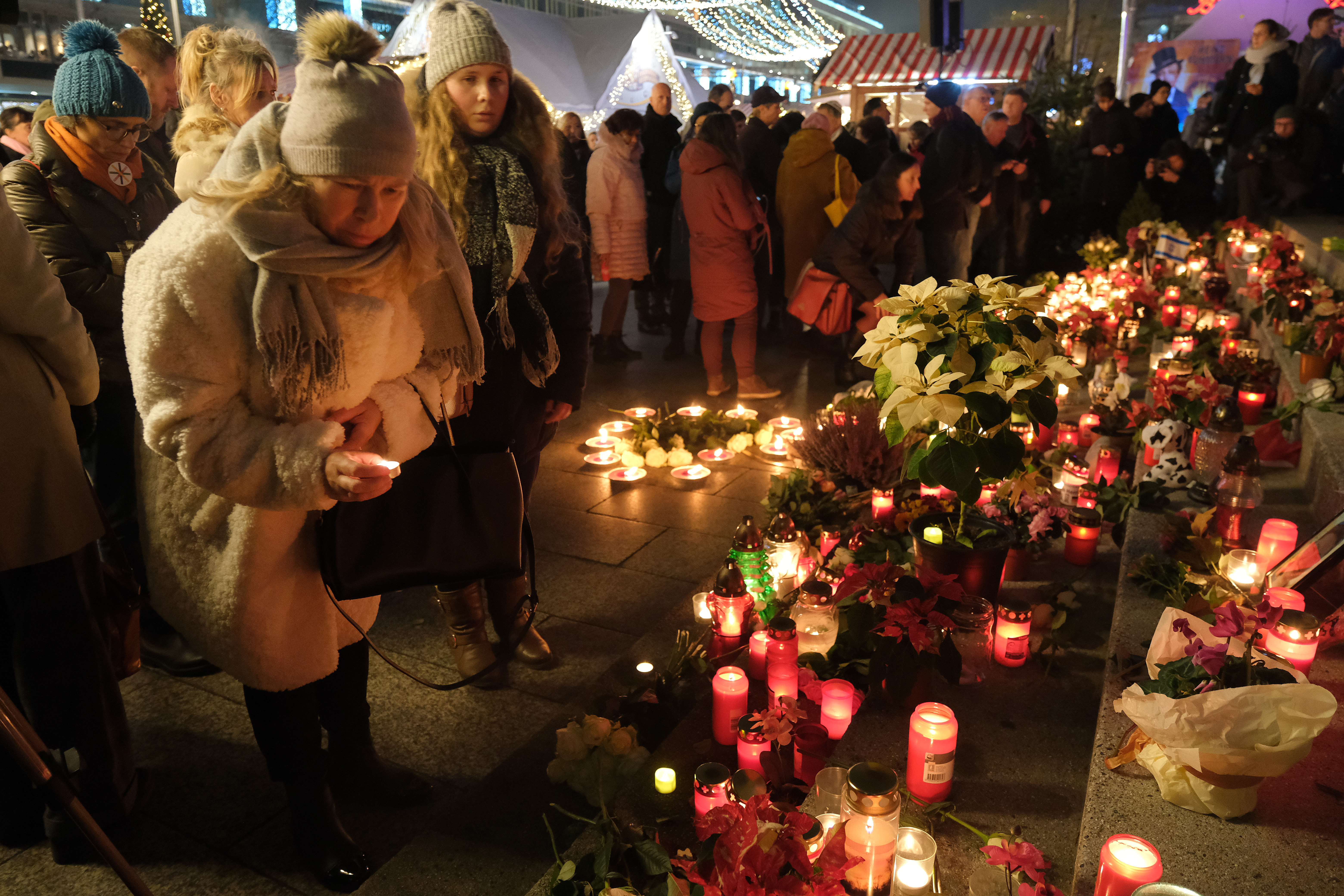 BERLIN, GERMANY - DECEMBER 19: Members of the public stand at the memorial to commemorate the 2016 Christmas market terror attack at Breitscheidplatz shortly after an official ceremony on the third anniversary of the attack on December 19, 2019 in Berlin, Germany. (Photo by Sean Gallup/Getty Images)