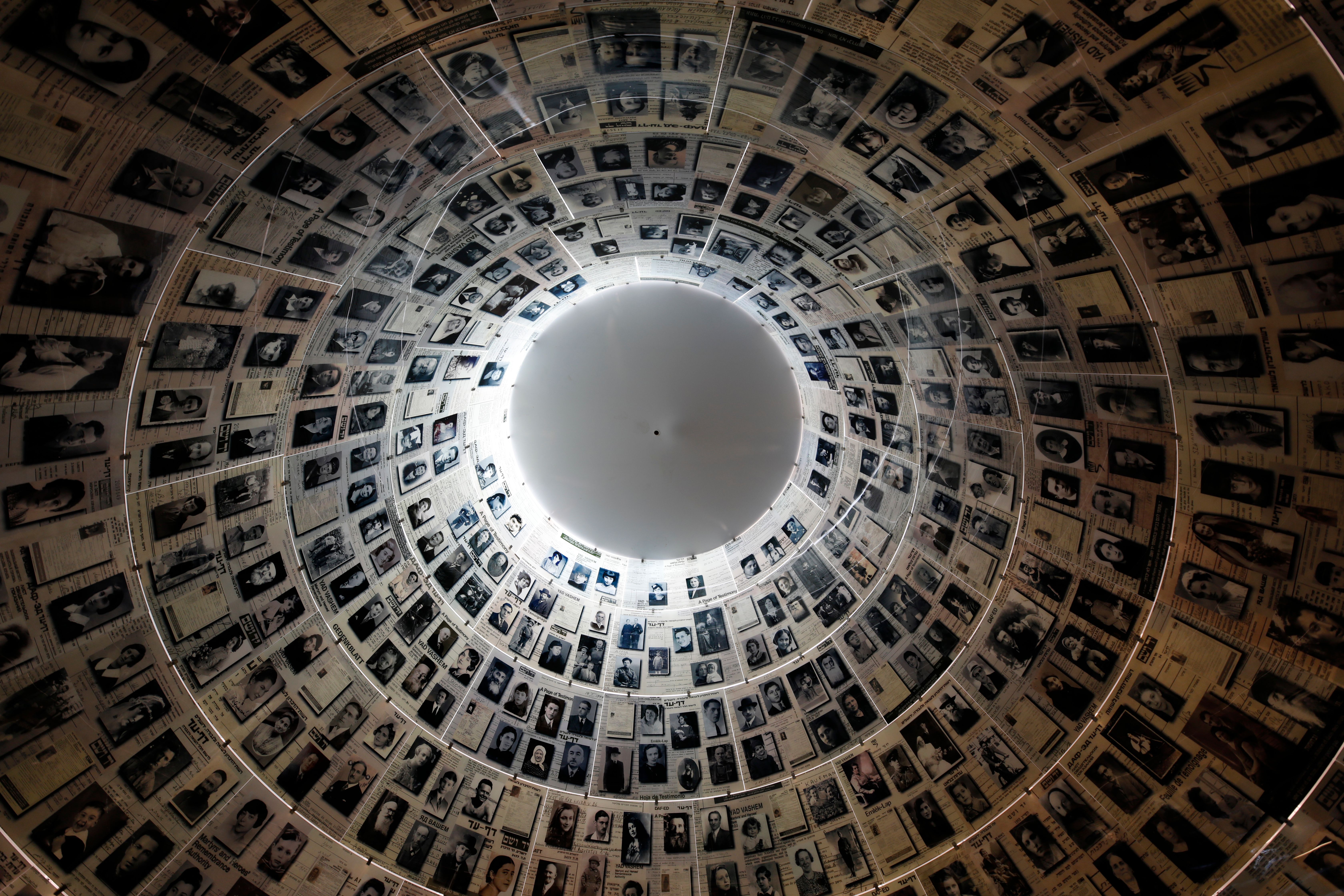 A picture taken on April 20, 2020, shows a view of the cieling in the Hall of Names, bearing names and pictures of Jewish Holocaust victims, at the Yad Vashem Holocaust memorial museum in Jerusalem. - Movement and travel restrictions in place to contain the pandemic have forced this week's Holocaust Remembrance Day -- Yom HaShoah in Hebrew -- to be exclusively digital for the first time. In a normal year, symbolic events are organised at various locations, notably with survivors at the sites in Europe where the Nazis built concentration and extermination camps. This year, testimonials from survivors will be streamed online and featured in a pre-recorded ceremony to be broadcast in Israel by Jerusalem's Yad Vashem Holocaust memorial centre, when Yom HaShoah begins on this evening. (Photo by MENAHEM KAHANA / AFP) (Photo by MENAHEM KAHANA/AFP via Getty Images)