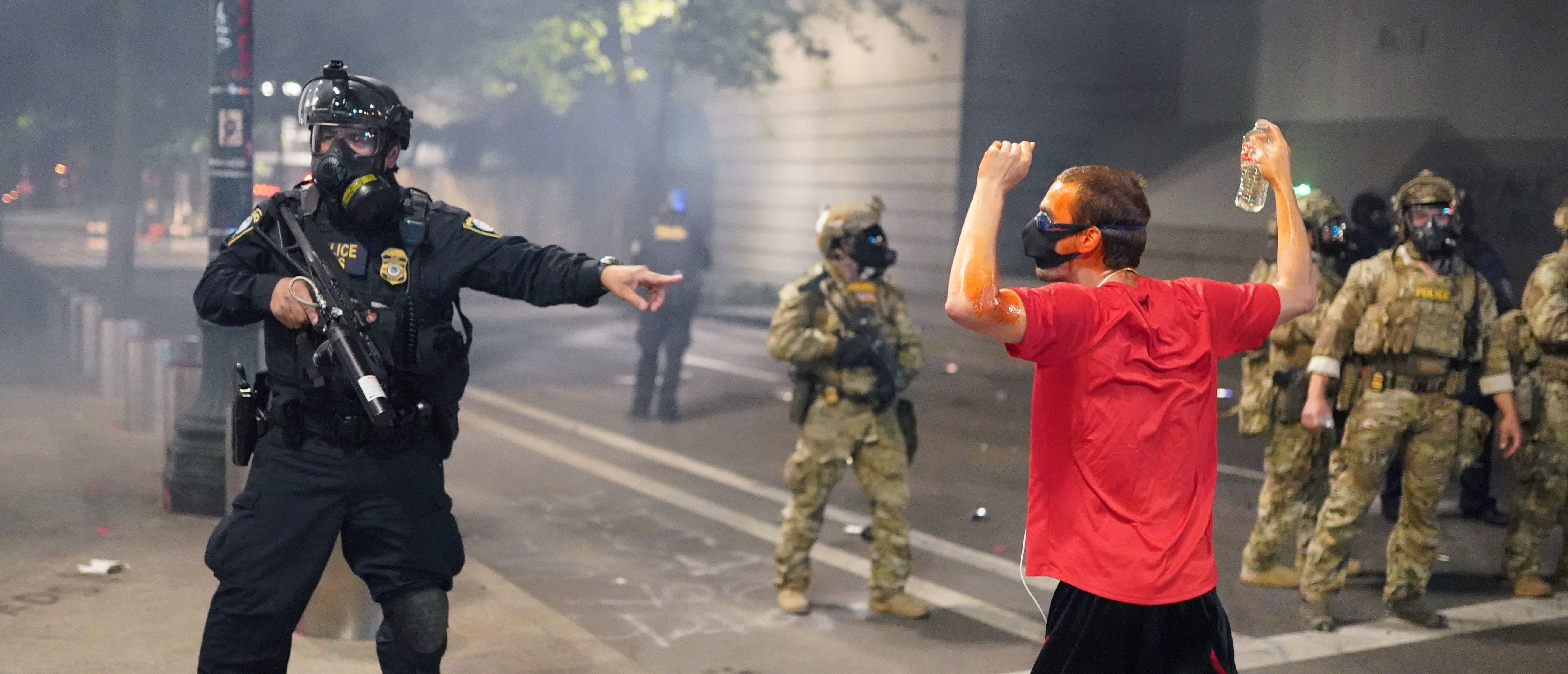 A federal officer tells fellow officers to arrest a protester in front of the Mark O. Hatfield U.S. Courthouse on July 21, 2020 in Portland, Oregon. State and city elected officials have called for the federal officers to leave Portland as clashes between protesters and federal police continue to escalate. (Photo by Nathan Howard/Getty Images)