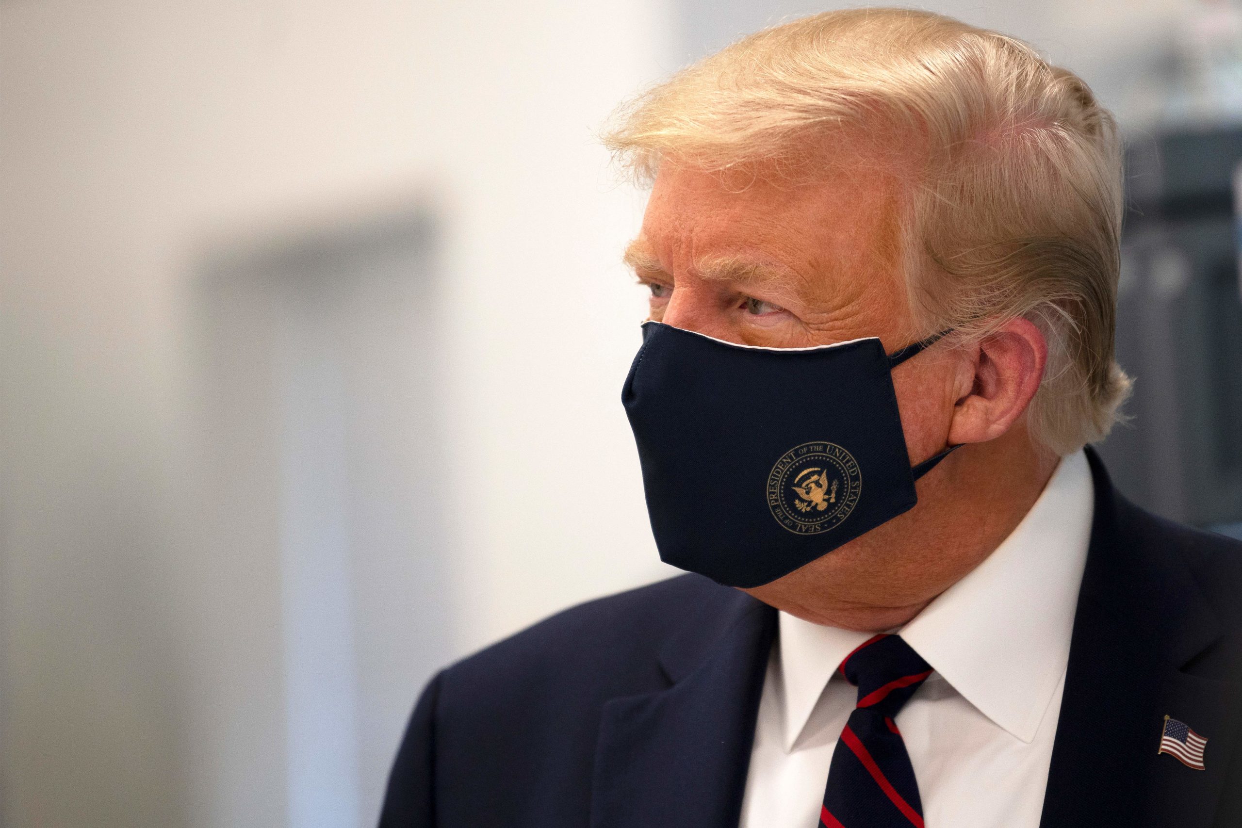 TOPSHOT - US President Donald Trump wears a mask as he tours a lab where they are making components for a potential vaccine at the Bioprocess Innovation Center at Fujifilm Diosynth Biotechnologies in Morrisville, North Carolina on July 27, 2020. (Photo by JIM WATSON / AFP) (Photo by JIM WATSON/AFP via Getty Images)
