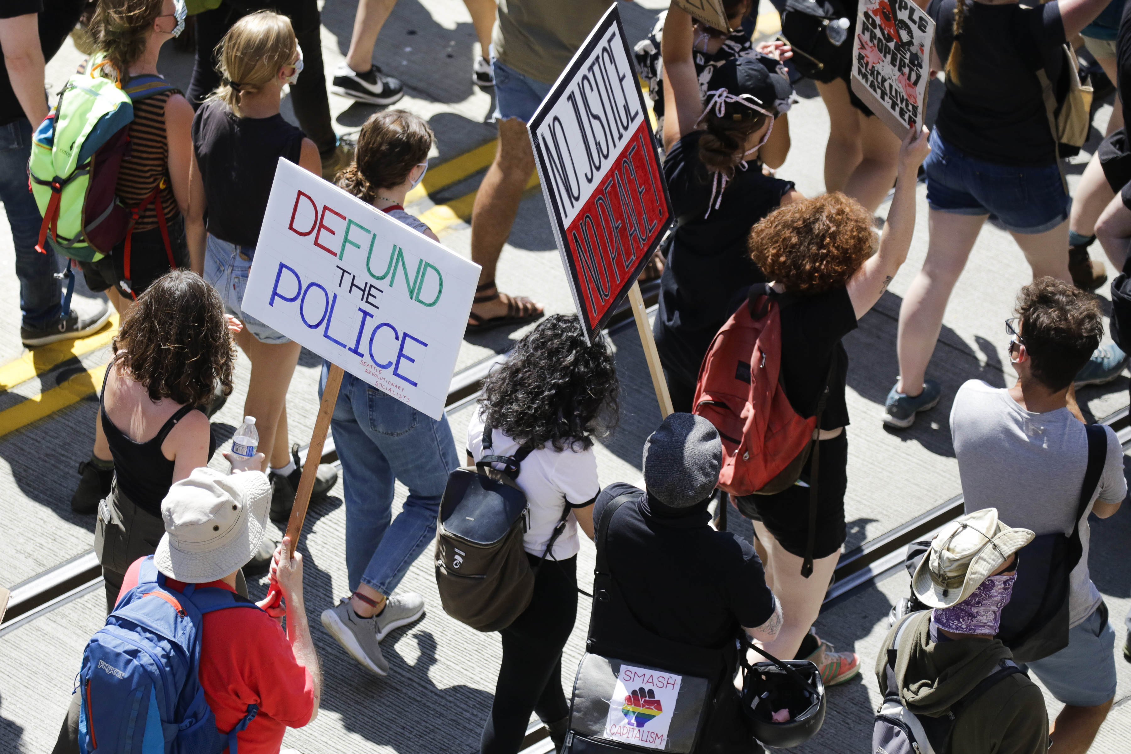 People carry signs during a "Defund the Police" march from King County Youth Jail to City Hall in Seattle, Washington on August 5, 2020. (Photo by Jason Redmond/AFP via Getty Images)