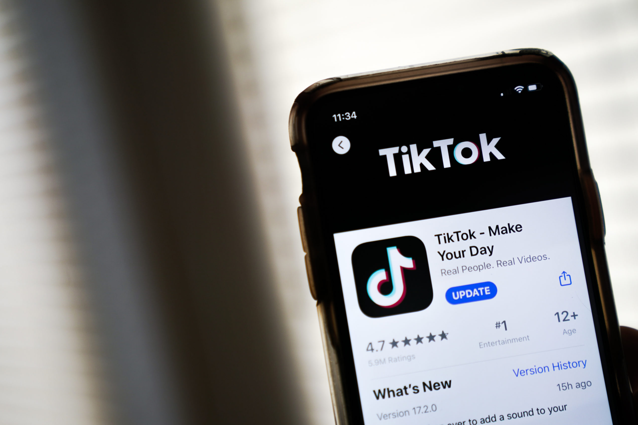 WASHINGTON, DC - AUGUST 07: In this photo illustration, the download page for the TikTok app is displayed on an Apple iPhone on August 7, 2020 in Washington, DC. On Thursday evening, President Donald Trump signed an executive order that bans any transactions between the parent company of TikTok, ByteDance, and U.S. citizens due to national security reasons. The president signed a separate executive order banning transactions with China-based tech company Tencent, which owns the app WeChat. Both orders are set to take effect in 45 days. (Photo Illustration by Drew Angerer/Getty Images)
