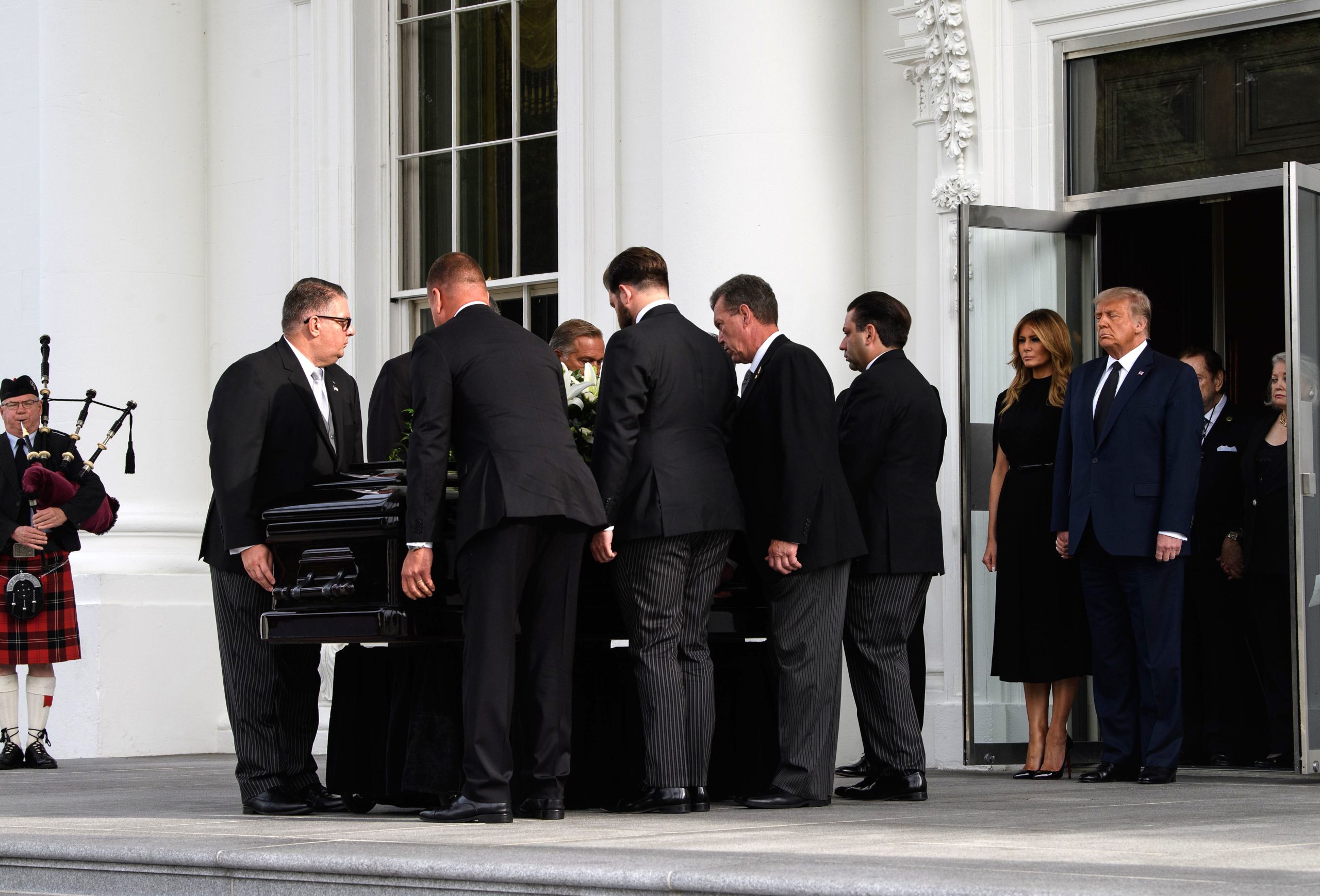 US President Donald Trump and First Lady Melania Trump watch pallbearers carry the casket of Trump's younger brother Robert, following a memorial service at the White House in Washington, DC, on August 21, 2020. (Nicholas Kamm/AFP via Getty Images)