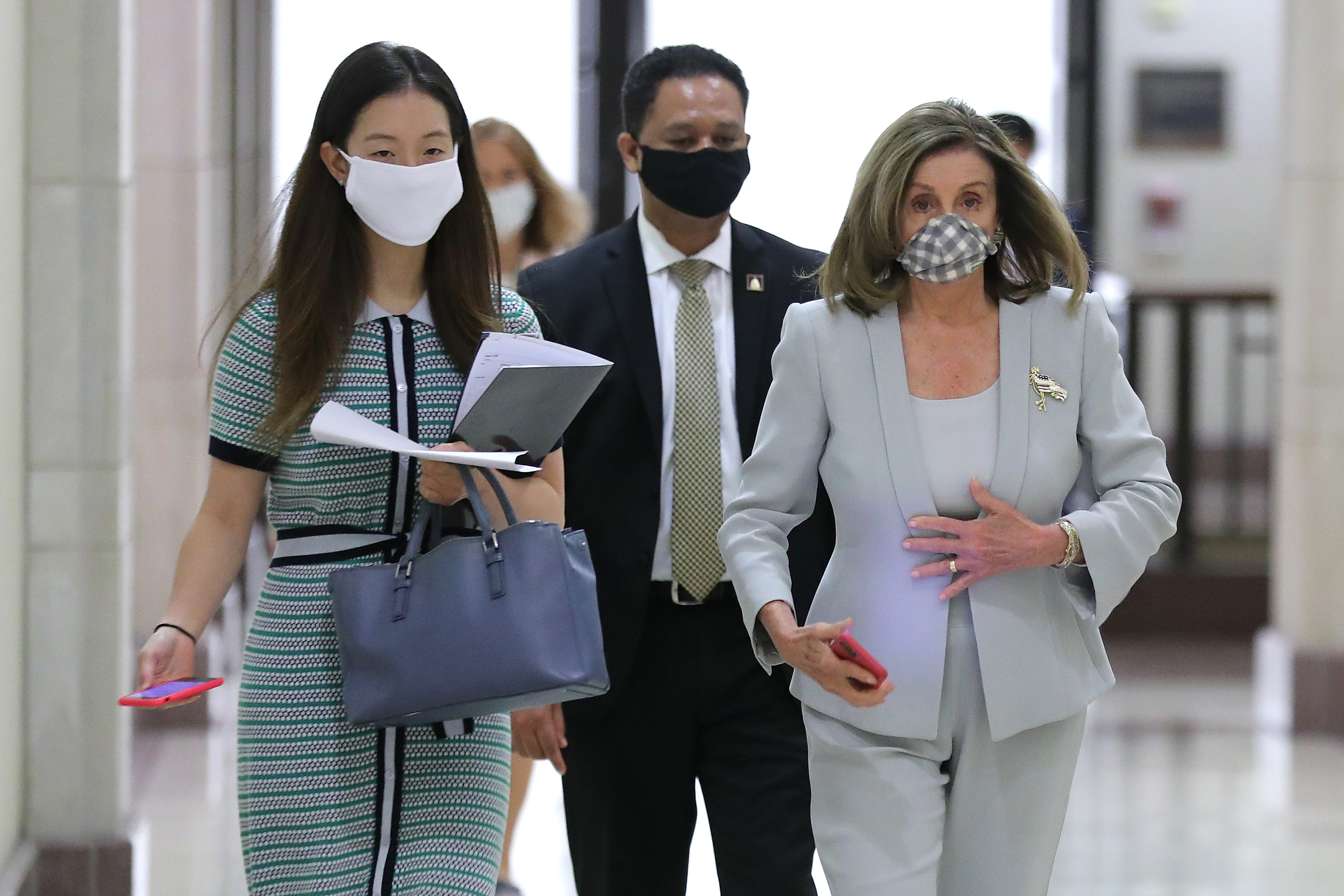 Speaker of the House Nancy Pelosi (D-CA) (R) returns to her office following a news conference in the U.S. Capitol Visitors Center August 13, 2020 in Washington, DC. (Chip Somodevilla/Getty Images)