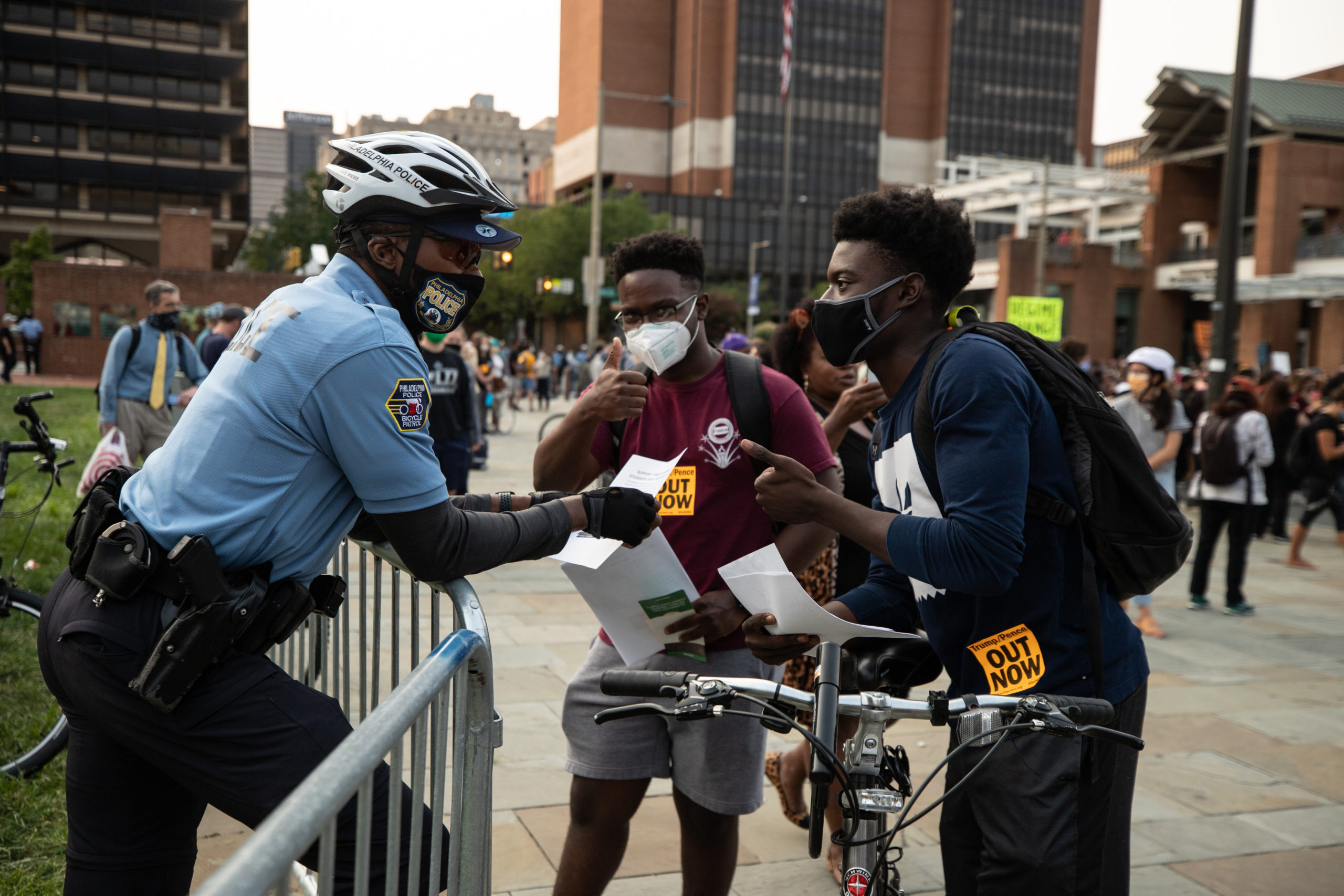 Two college students tell an officer about how they're spreading awareness about their school charging full tuition despite going online in Philadelphia, Pennsylvania on Sept. 15, 2020. (Photo: Kaylee Greenlee / DCNF)