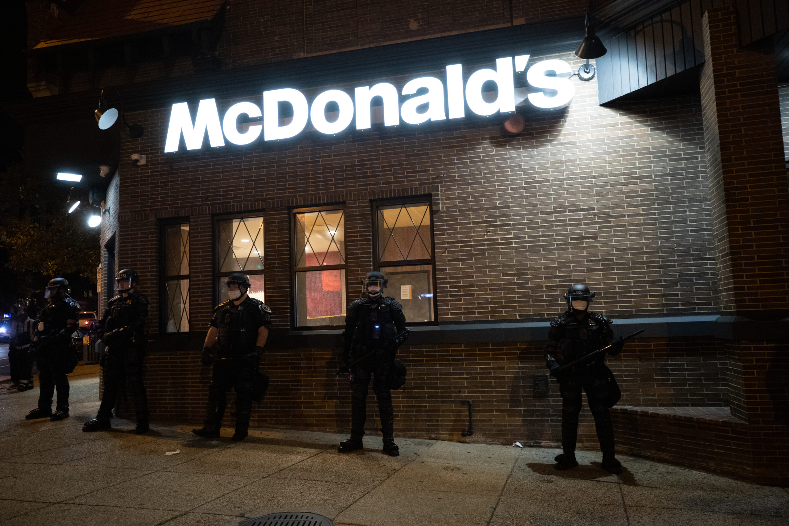 Metropolitan Police Department officers stood outside of a McDonald's restaurant in what appeared to be riot gear in Adams Morgan, Washington, D.C. on Sept. 23. (Photo: Kaylee Greenlee / DCNF)