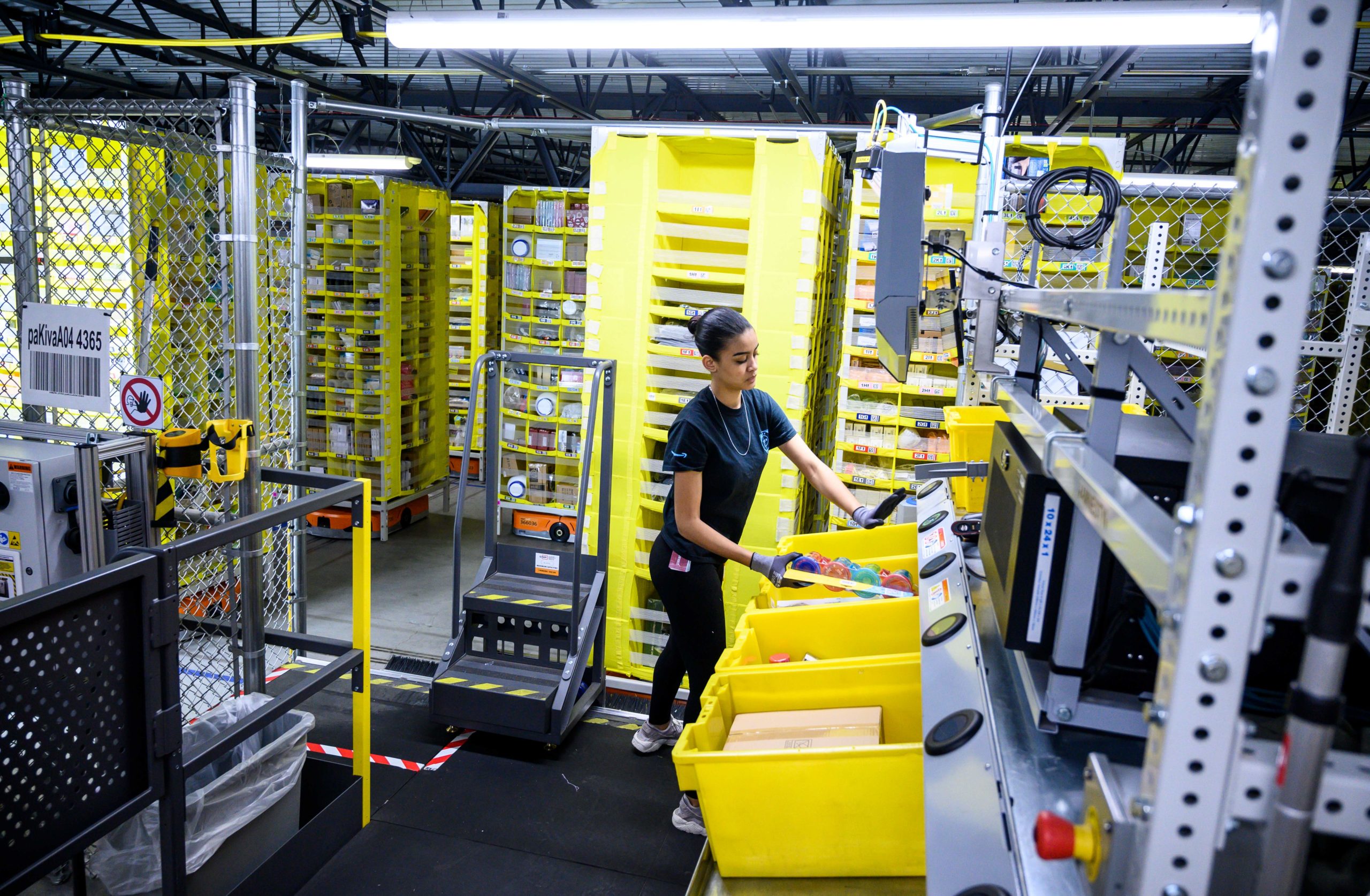 A woman works at a distribution station at the 855,000-square-foot Amazon fulfillment center in Staten Island, New York in 2019. (Johannes Eisele/AFP via Getty Images)