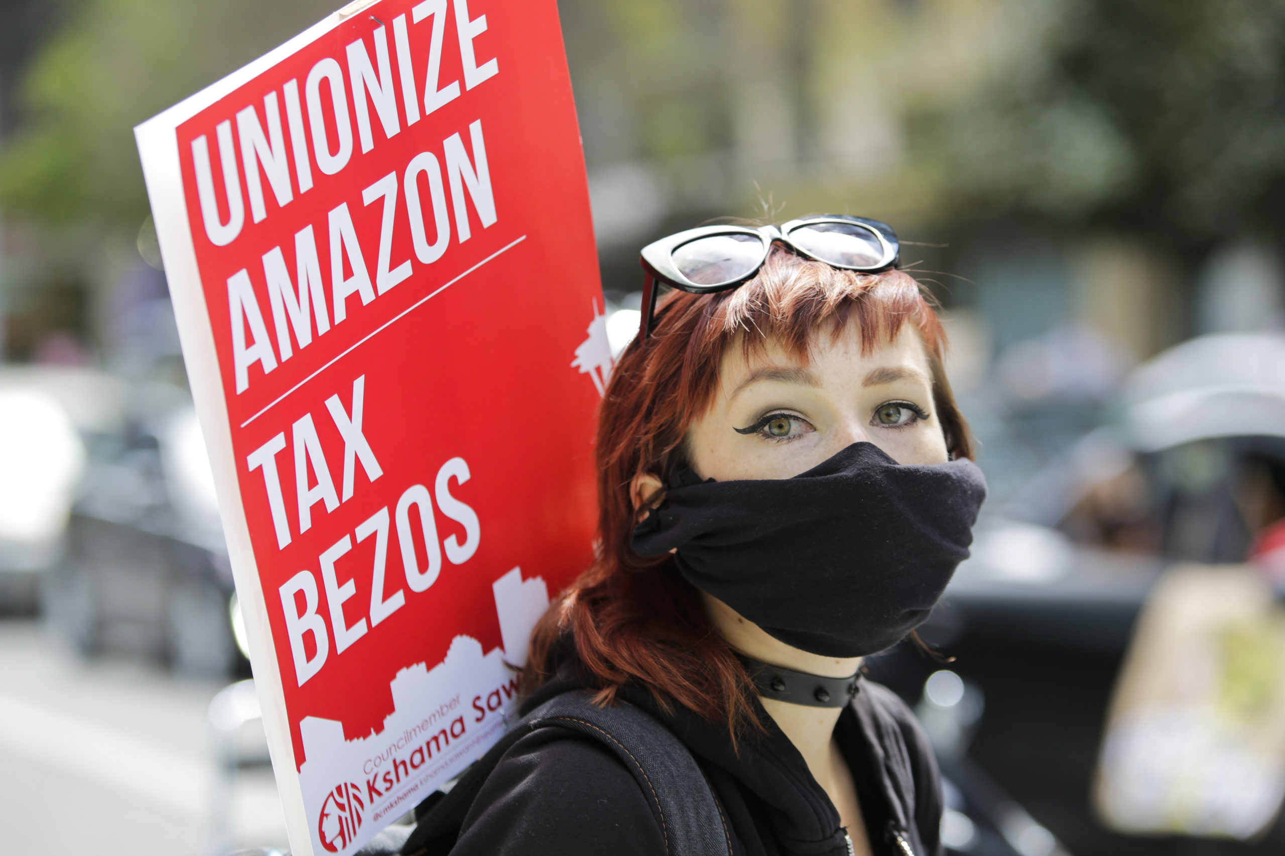 Protesters wearing face masks participate in a protest at the Amazon Spheres to demand the Seattle City Council tax the city's largest businesses in Seattle, Washington on May 1, 2020. (Jason Redmond/AFP via Getty Images)
