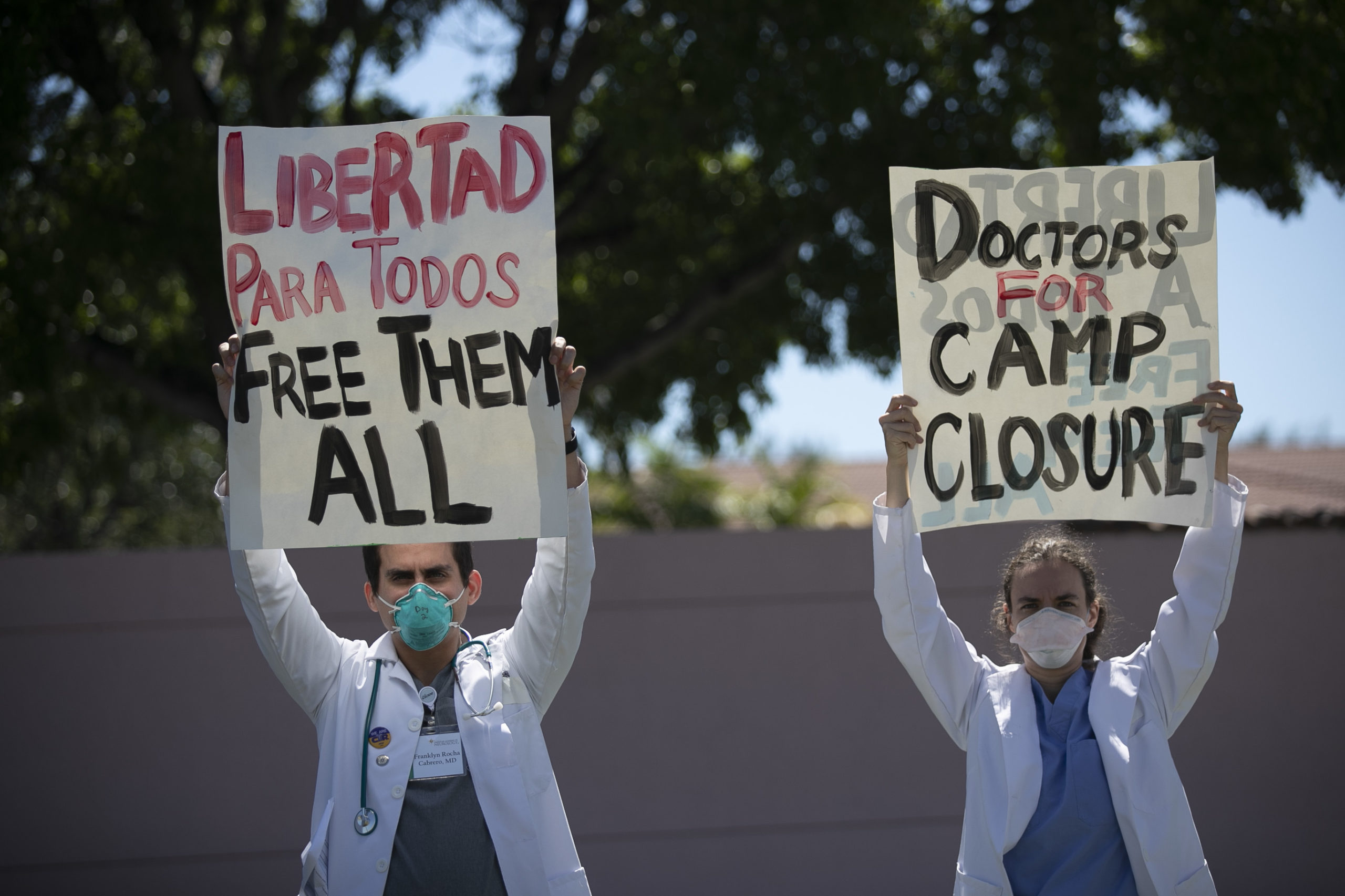 Dr. Franklyn Rocha Cabrero and Dr. Claudia A. Alvarez join with protesters outside of the Immigration and Customs Enforcement's Broward Transitional Center on May 01, 2020 in Pompano Beach, Florida. (Joe Raedle/Getty Images)