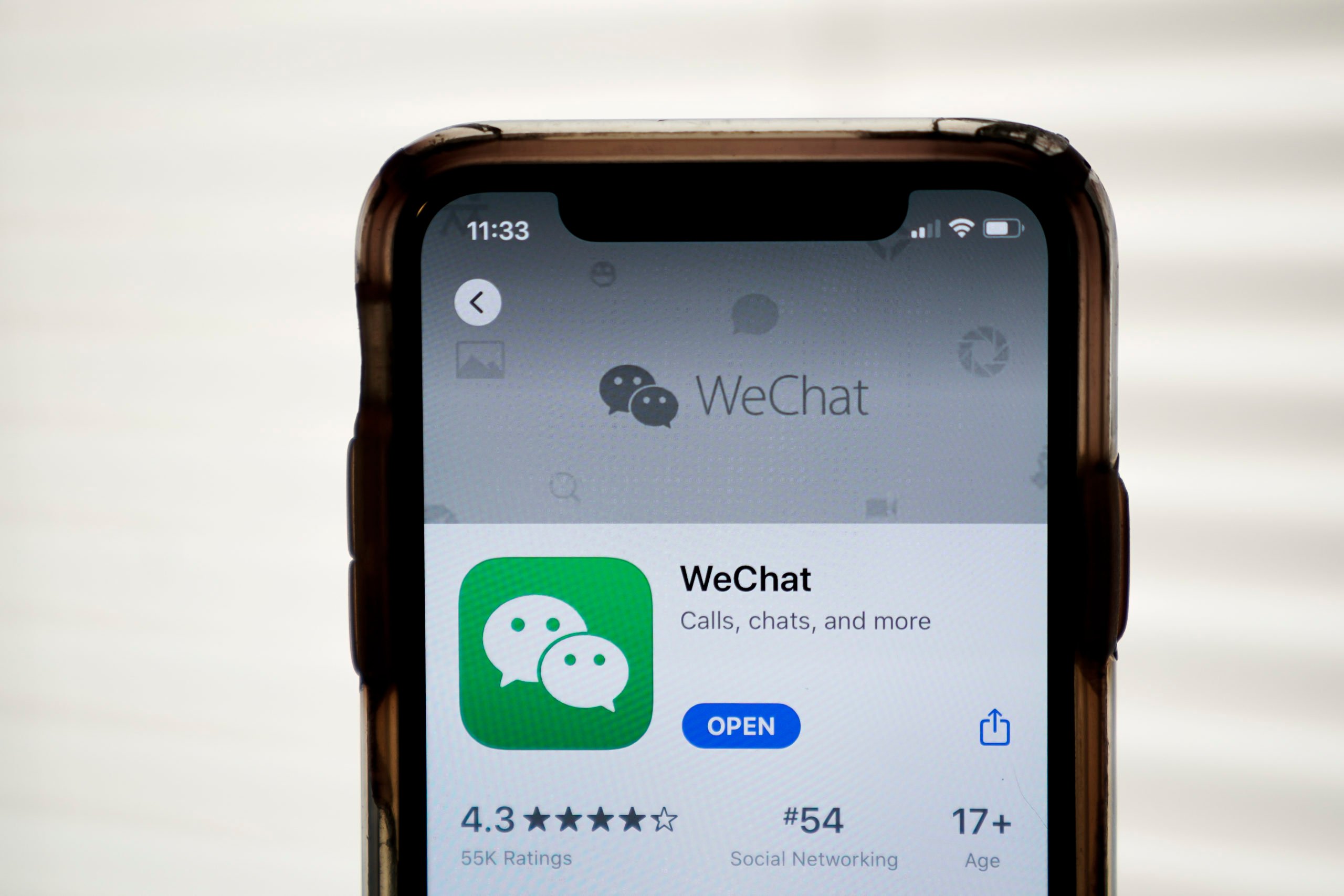 WASHINGTON, DC - AUGUST 07: In this photo illustration, the WeChat app is displayed in the App Store on an Apple iPhone on August 7, 2020 in Washington, DC. On Thursday evening, President Donald Trump signed an executive order that bans any transactions between the parent company of TikTok, ByteDance, and U.S. citizens due to national security reasons. The president signed a separate executive order banning transactions with China-based tech company Tencent, which owns the app WeChat. Both orders are set to take effect in 45 days. (Photo Illustration by Drew Angerer/Getty Images)
