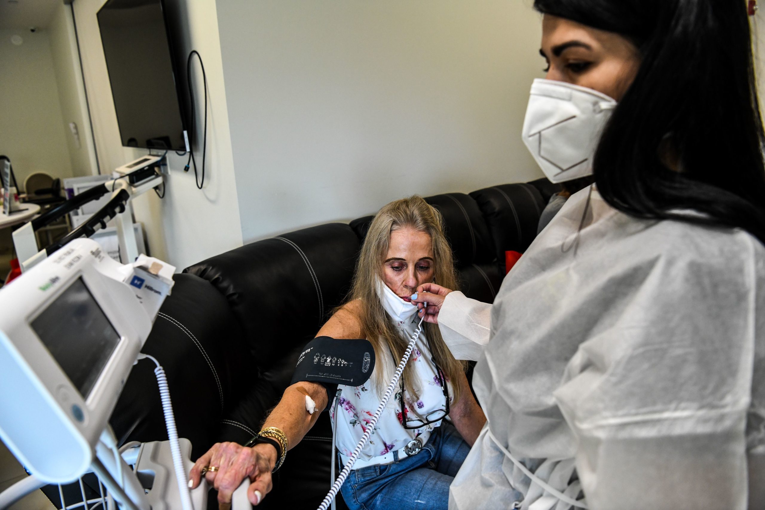 A volunteer is examined by a Nurse Practitioner as she participates in a COVID-19 vaccine study at the Research Centers of America (RCA) in Hollywood, Florida, on August 13, 2020 (CHANDAN KHANNA/AFP via Getty Images)
