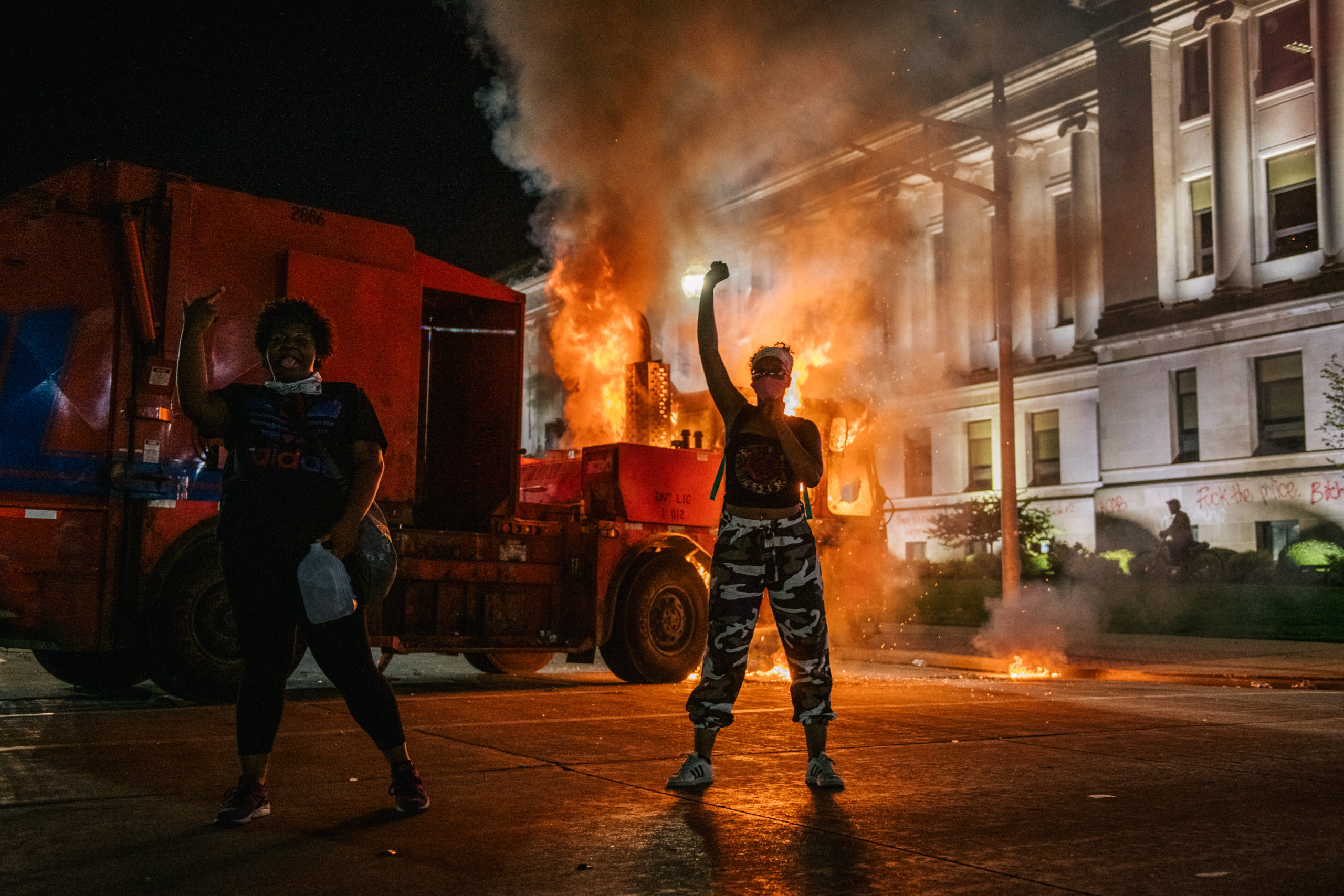 KENOSHA, WI - AUGUST 24: Demonstrators chant in front of a burning truck on August 24, 2020 in Kenosha, Wisconsin. This is the second night of rioting after the shooting of Jacob Blake, 29, on August 23. Blake was shot multiple times in the back by Wisconsin police officers after attempting to enter into the drivers side of a vehicle. (Photo by Brandon Bell/Getty Images)