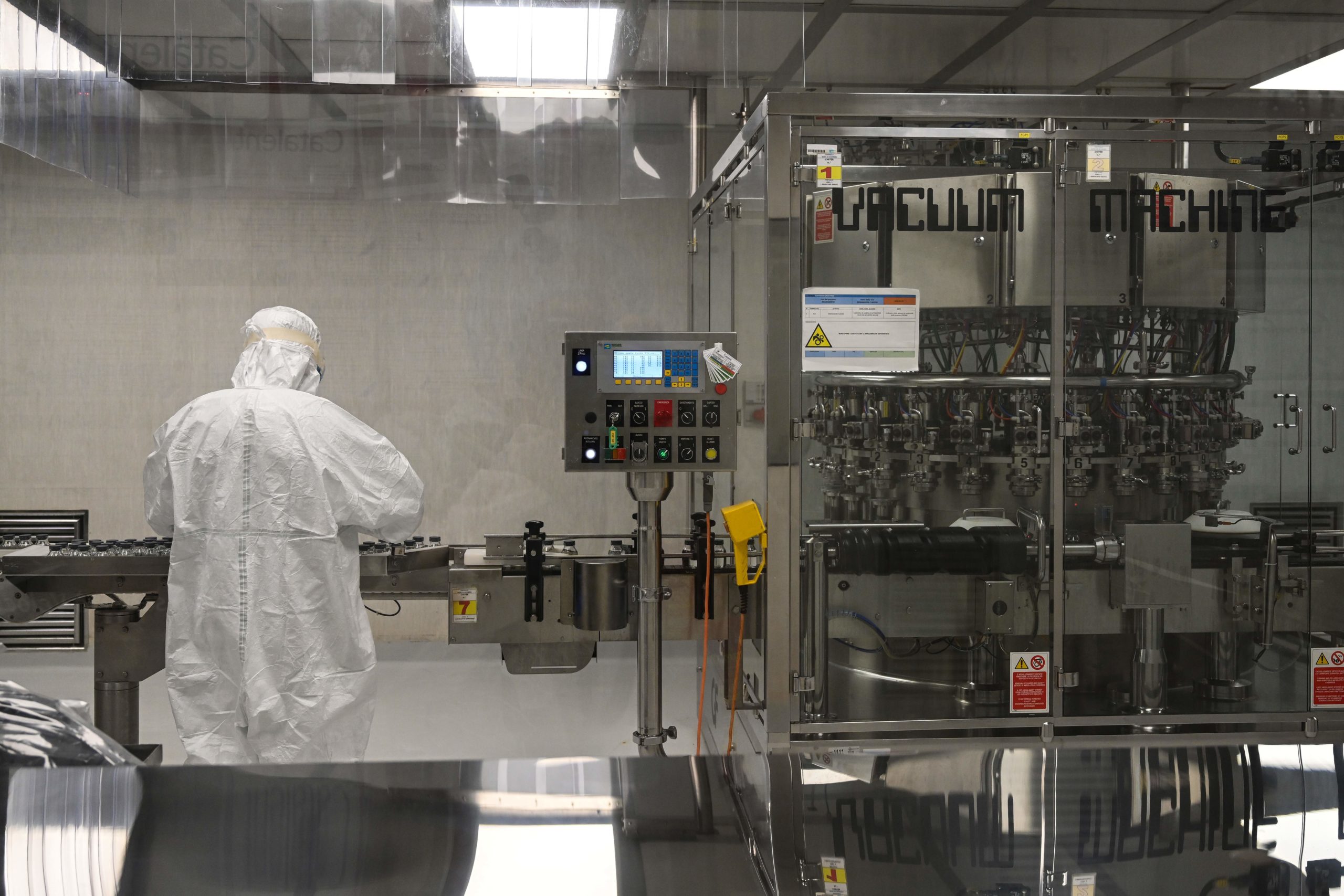 A laboratory technician takes part in filling and packaging tests for the large-scale production and supply of the University of Oxfords COVID-19 vaccine candidate, AZD1222, conducted on a high-performance aseptic vial filling line on September 11, 2020 at the Italian biologics manufacturing facility of multinational corporation Catalent in Anagni, southeast of Rome, during the COVID-19 infection, caused by the novel coronavirus. - Catalent Biologics manufacturing facility in Anagni, Italy will serve as the launch facility for the large-scale production and supply of the University of Oxfords Covid-19 vaccine candidate, AZD1222, providing large-scale vial filling and packaging to British-Swedish multinational pharmaceutical and biopharmaceutical company AstraZeneca. (Photo by Vincenzo PINTO / AFP) (Photo by VINCENZO PINTO/AFP via Getty Images)