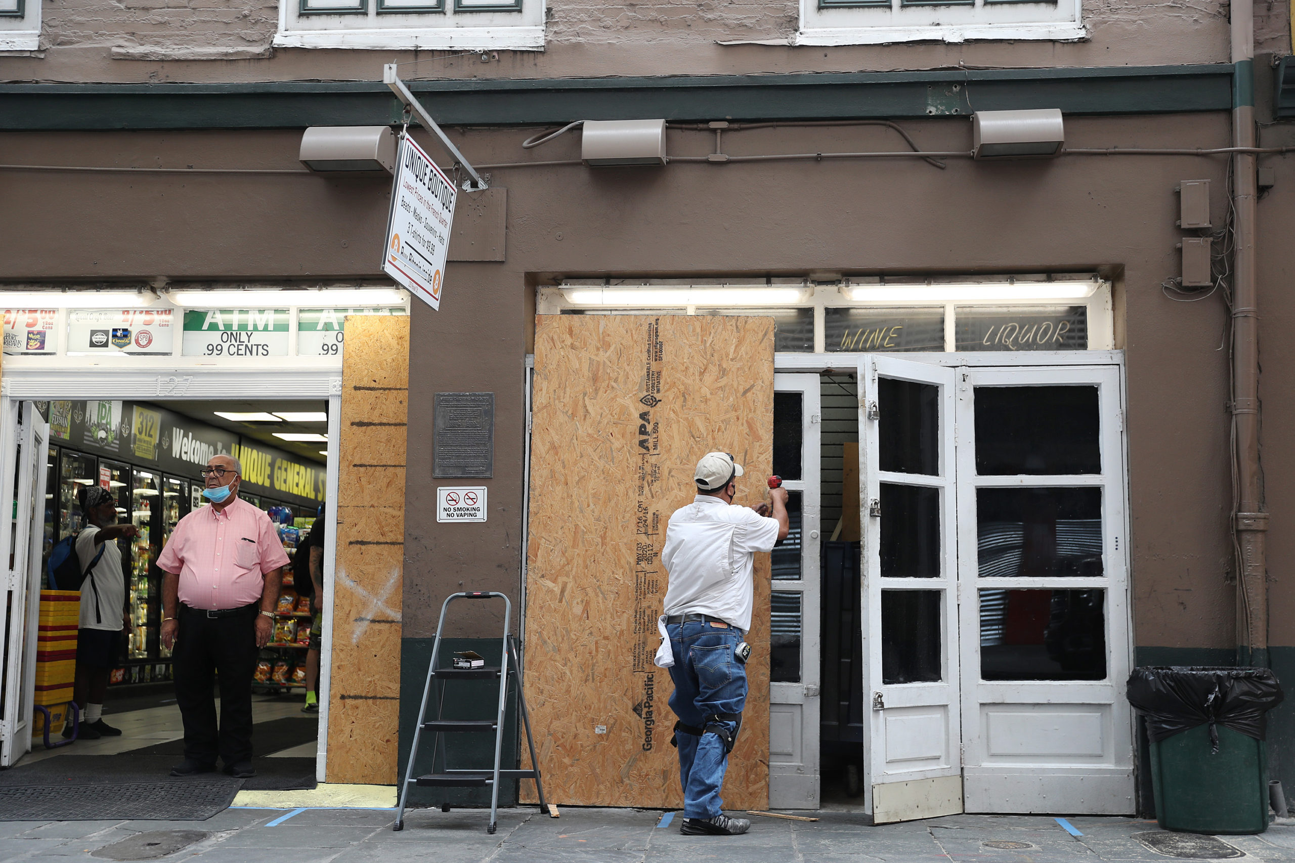 Luis A. Sanabria puts plywood over the windows of a business in the historic French Quarter before the possible arrival of Hurricane Sally on September 14, 2020 in New Orleans, Louisiana. The storm is threatening to bring heavy rain, high winds and a dangerous storm surge from Louisiana to Florida. (Photo by Joe Raedle/Getty Images)