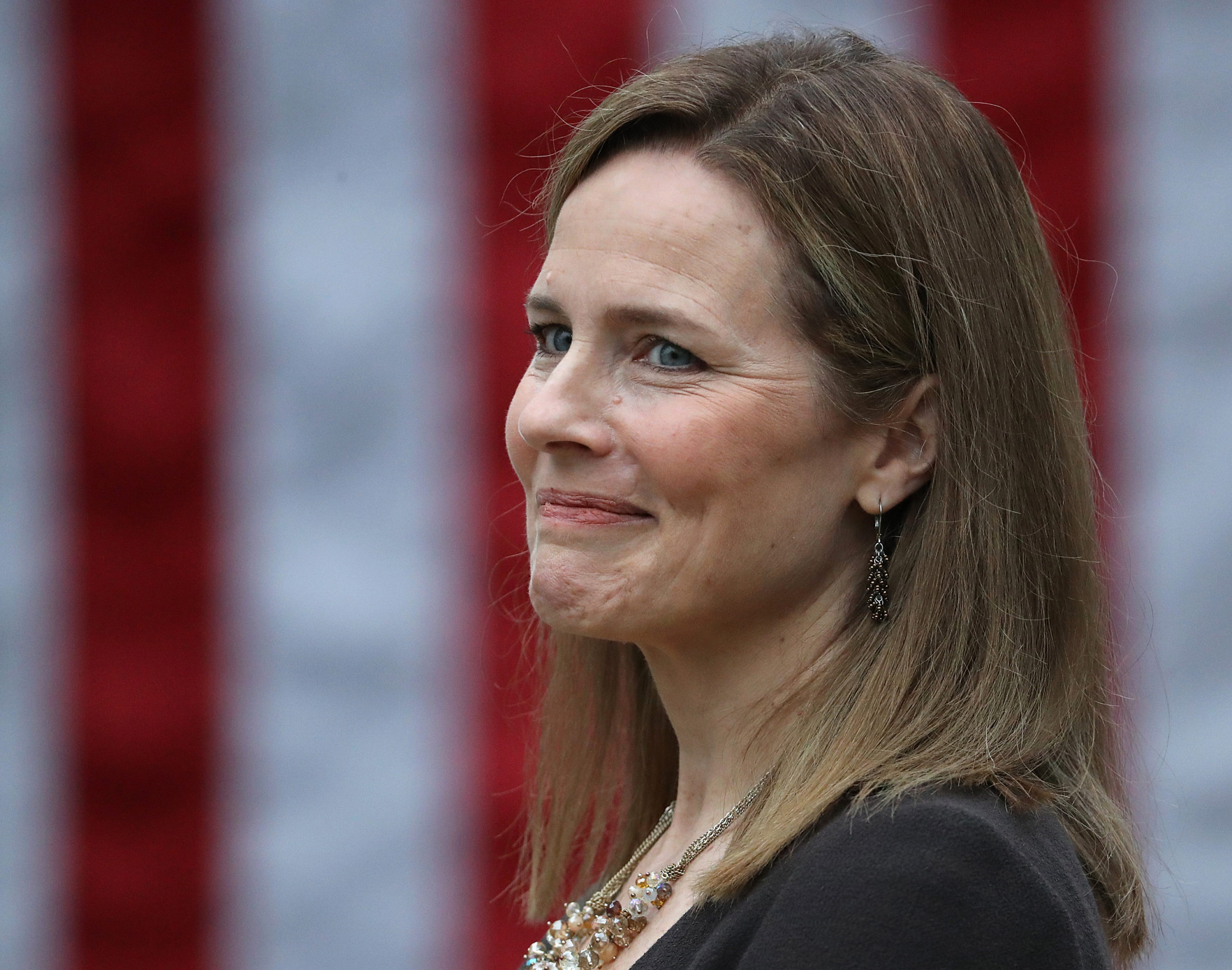 WASHINGTON, DC - SEPTEMBER 26: Seventh U.S. Circuit Court Judge Amy Coney Barrett looks on while being introduced by U.S. President Donald Trump as his nominee to the Supreme Court during an event in the Rose Garden at the White House September 26, 2020 in Washington, DC. With 38 days until the election, Trump tapped Barrett to be his third Supreme Court nominee in just four years and to replace the late Associate Justice Ruth Bader Ginsburg, who will be buried at Arlington National Cemetery on Tuesday. (Photo by Chip Somodevilla/Getty Images)