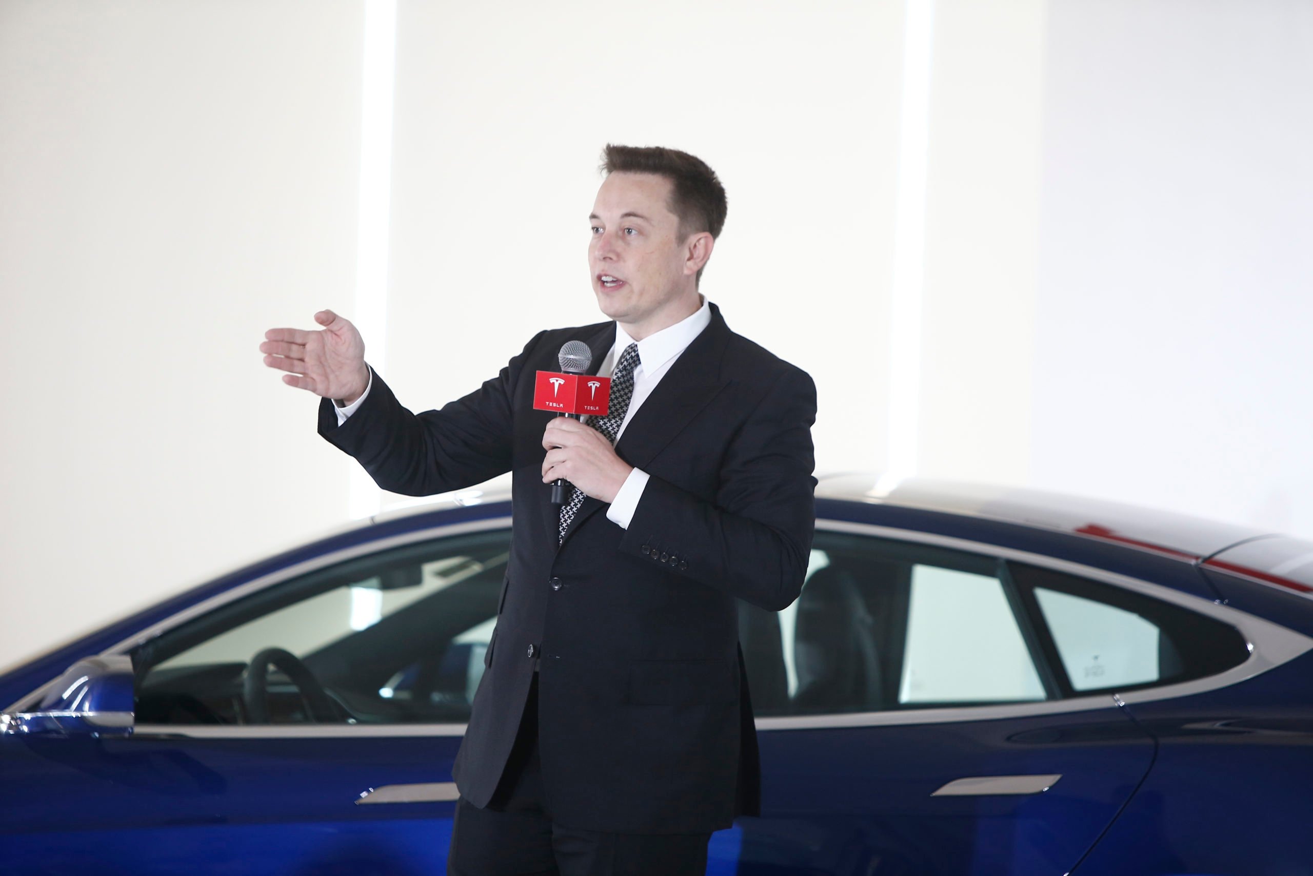 BEIJING, CHINA - OCTOBER 23: (CHINA OUT) Elon Musk, Chairman, CEO and Product Architect of Tesla Motors, addresses a press conference to declare that the Tesla Motors releases v7.0 System in China on a limited basis for its Model S, which will enable self-driving features such as Autosteer for a select group of beta testers on October 23, 2015 in Beijing, China. The v7.0 system includes Autosteer, a new Autopilot feature. While it's not absolutely self-driving and the driver still need to hold the steering wheel and be mindful of road conditions and surrounding traffic when using Autosteer. When set to the new Autosteer mode, graphics on the driver's display will show the path the Model S is following, post the current speed limit and indicate if a car is in front of the Tesla. (Photo by VCG/VCG via Getty Images)