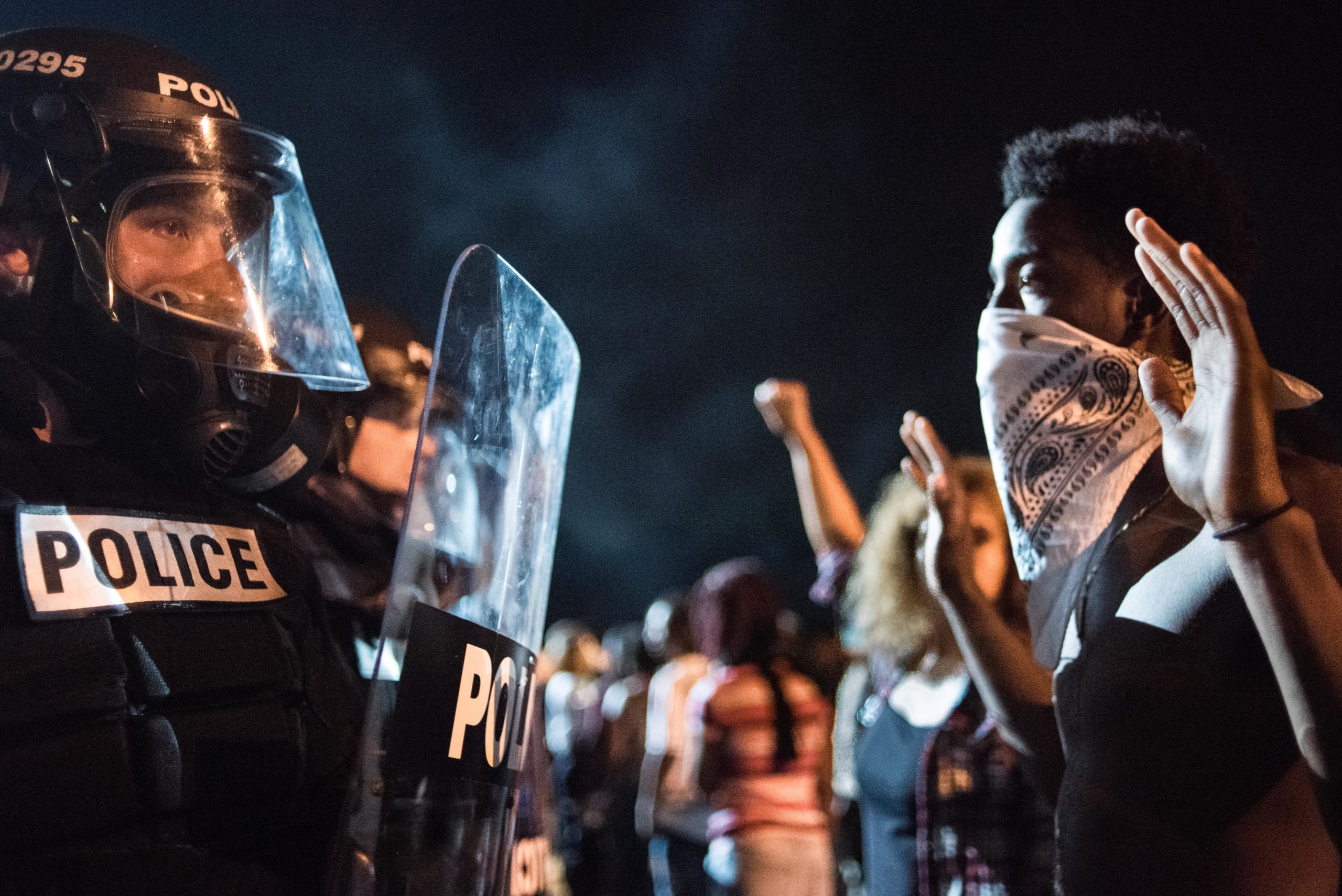 CHARLOTTE, NC - SEPTEMBER 21: Police officers face off with protesters on the I-85 (Interstate 85) during protests in the early hours of September 21, 2016 in Charlotte, North Carolina. The protests began last night, following the fatal shooting of 43-year-old Keith Lamont Scott by a police officer at an apartment complex near UNC Charlotte. (Photo by Sean Rayford/Getty Images)