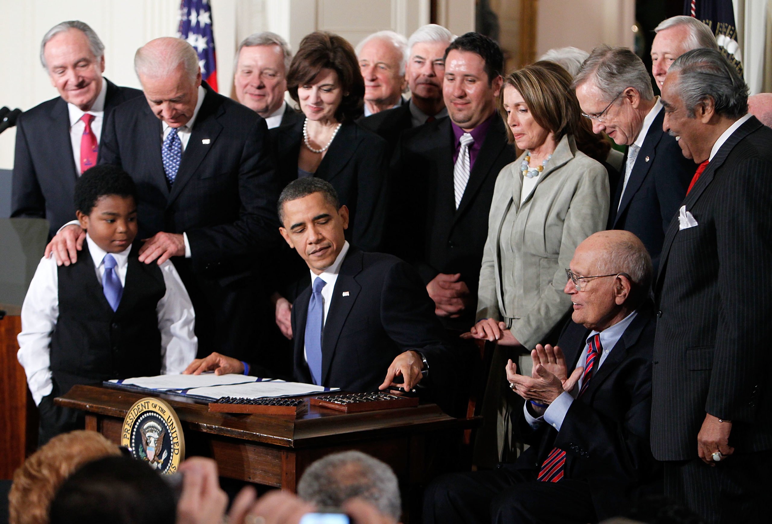 President Barack Obama signs the Affordable Health Care for America Act during a ceremony with fellow Democrats in the East Room of the White House March 23, 2010 in Washington, DC. (Alex Wong/Getty Images)