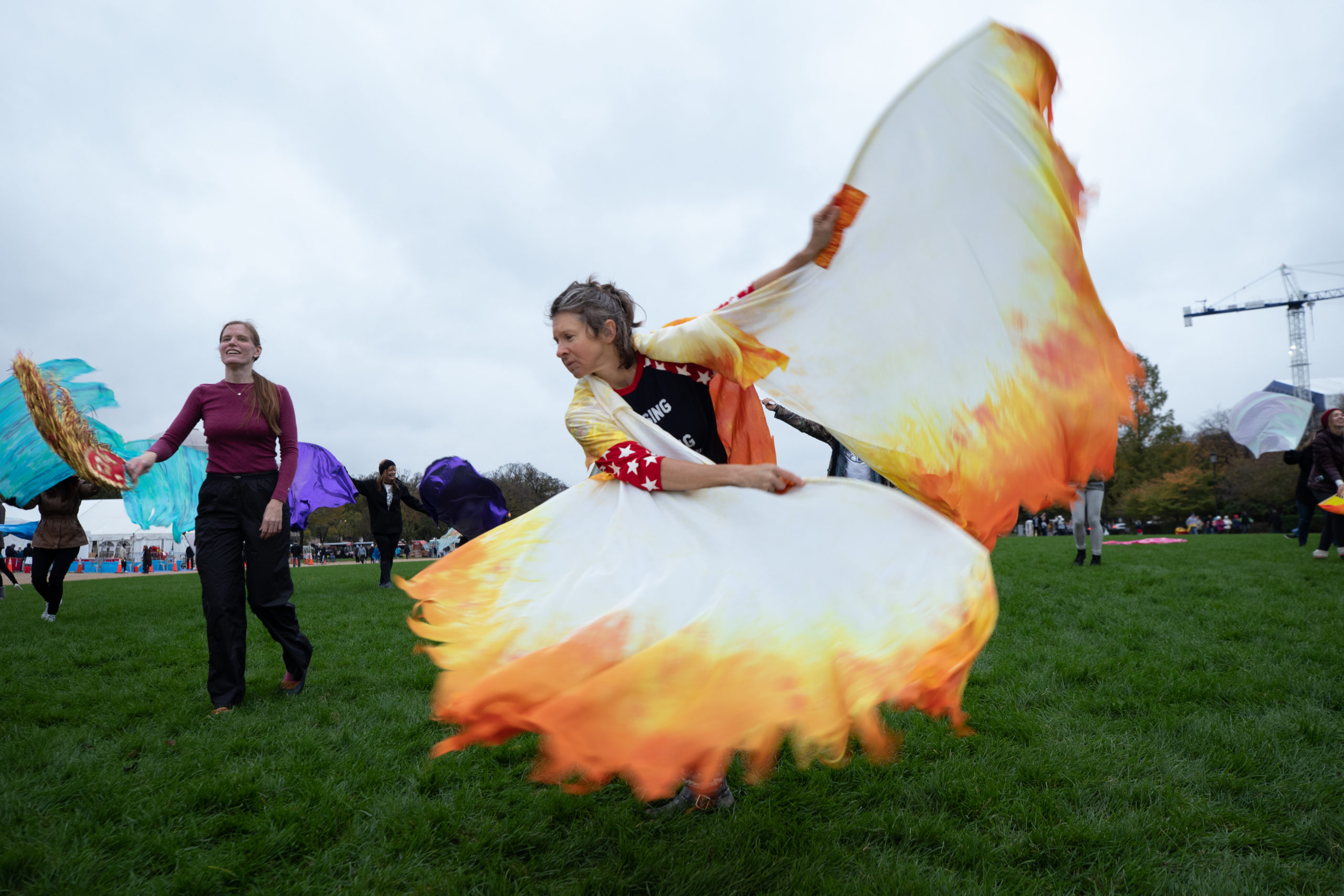 An attendee danced to worship music while holding fabric sheets resembling fire at the "Let Us Worship" protest in Washington, D.C. on October 25, 2020. (Kaylee Greenlee - DCNF)