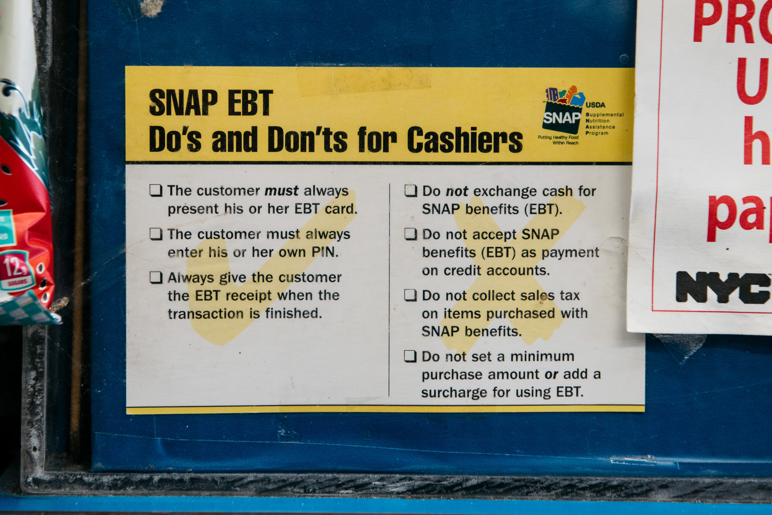 NEW YORK, NY - DECEMBER 05: A sign alerting customers about SNAP food stamps benefits is displayed in a Brooklyn grocery store on December 5, 2019 in New York City. Earlier this week the Trump Administration announced stricter requirements for food stamps benefits that would cut support for nearly 700,000 poor Americans. (Photo by Scott Heins/Getty Images)
