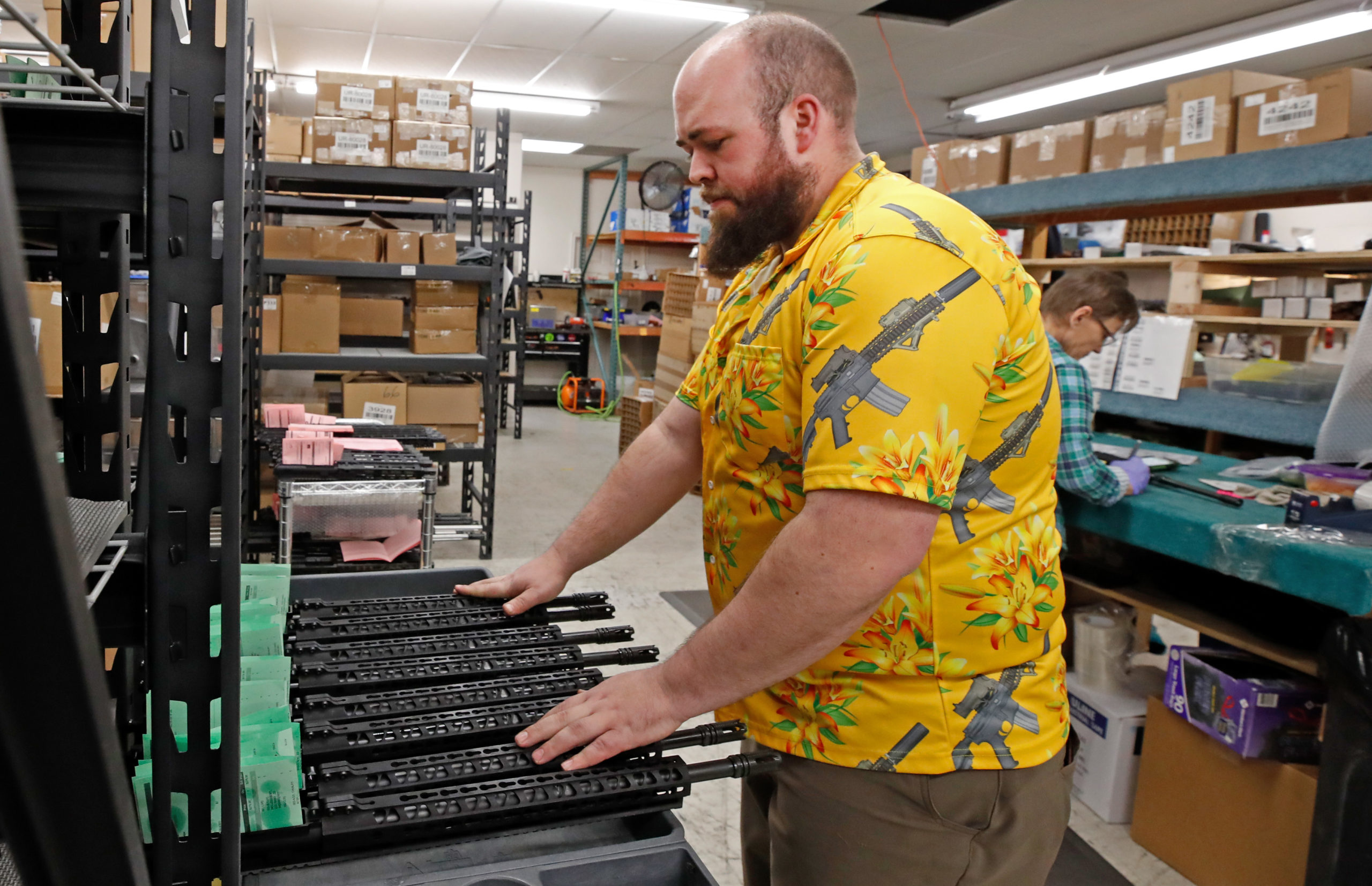 A worker moves finished AR-15 rifle uppers for storage at Delta Team Tactical in Orem, Utah on March 20, 2020. - Gun stores in the US are reporting a surge in sales of firearms as coronavirus fears trigger personal safety concerns. Delta Team Tactical has experienced a 3-4 times increase in gun sales and orders since the start of the COVID-19 crisis. (GEORGE FREY/AFP via Getty Images)