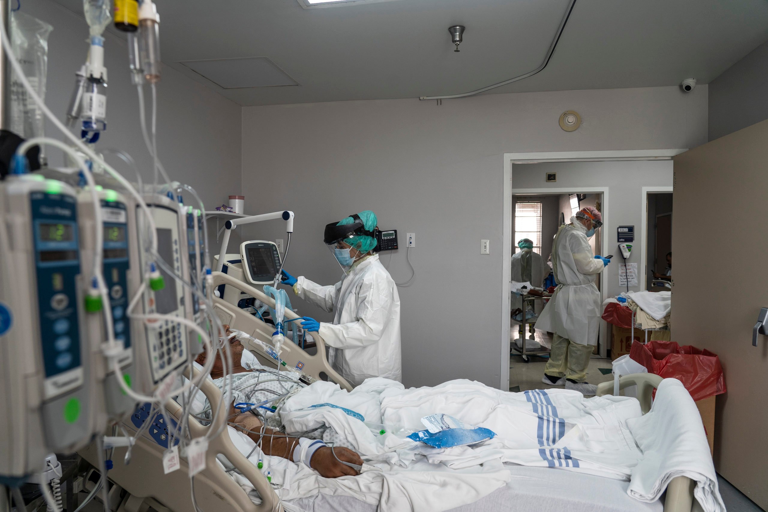 HOUSTON, TX - JUNE 30: (EDITORIAL USE ONLY) A member of the medical staff wearing full PPE treats a patient in the Covid-19 intensive care unit at the United Memorial Medical Center on June 30, 2020 in Houston, Texas. Covid-19 cases and hospitalizations have spiked since Texas reopened, pushing intensive-care wards to full capacity and sparking concerns about a surge in fatalities as the virus spreads. (Photo by Go Nakamura/Getty Images)