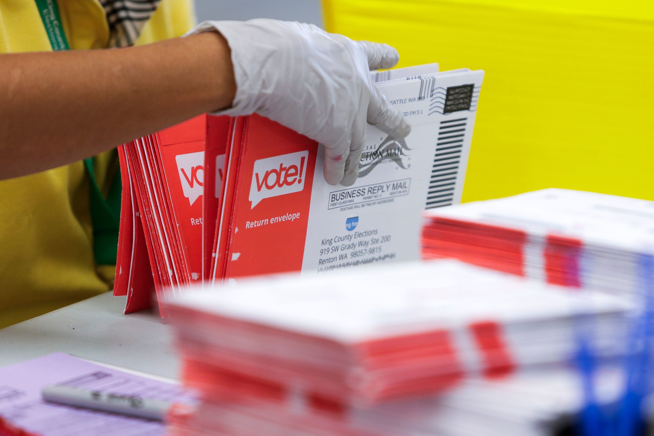 An election worker opens envelopes containing vote-by-mail ballots for the August 4 Washington state primary at King County Elections in Renton, Washington on August 3, 2020. (Photo by Jason Redmond / AFP) (Photo by JASON REDMOND/AFP via Getty Images)