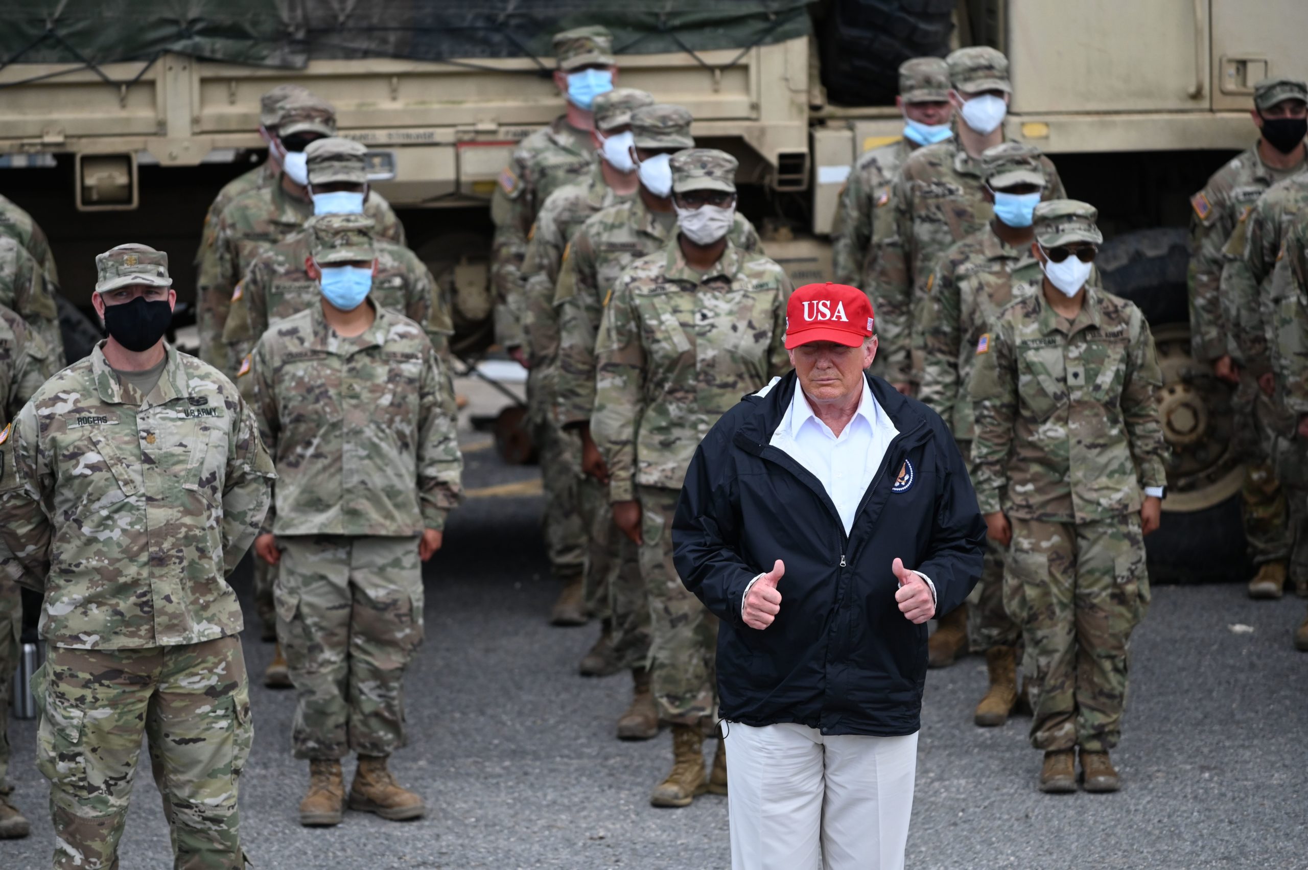 US President Donald Trump poses with National Guard troops in Lake Charles, Louisiana, on August 29, 2020. Trump surveyed damage in the area caused by Hurricane Laura. - At least 15 people were killed after Laura slammed into the southern US states of Louisiana and Texas, authorities and local media said on August 28. (Photo by Roberto Schmidt/AFP via Getty Images)