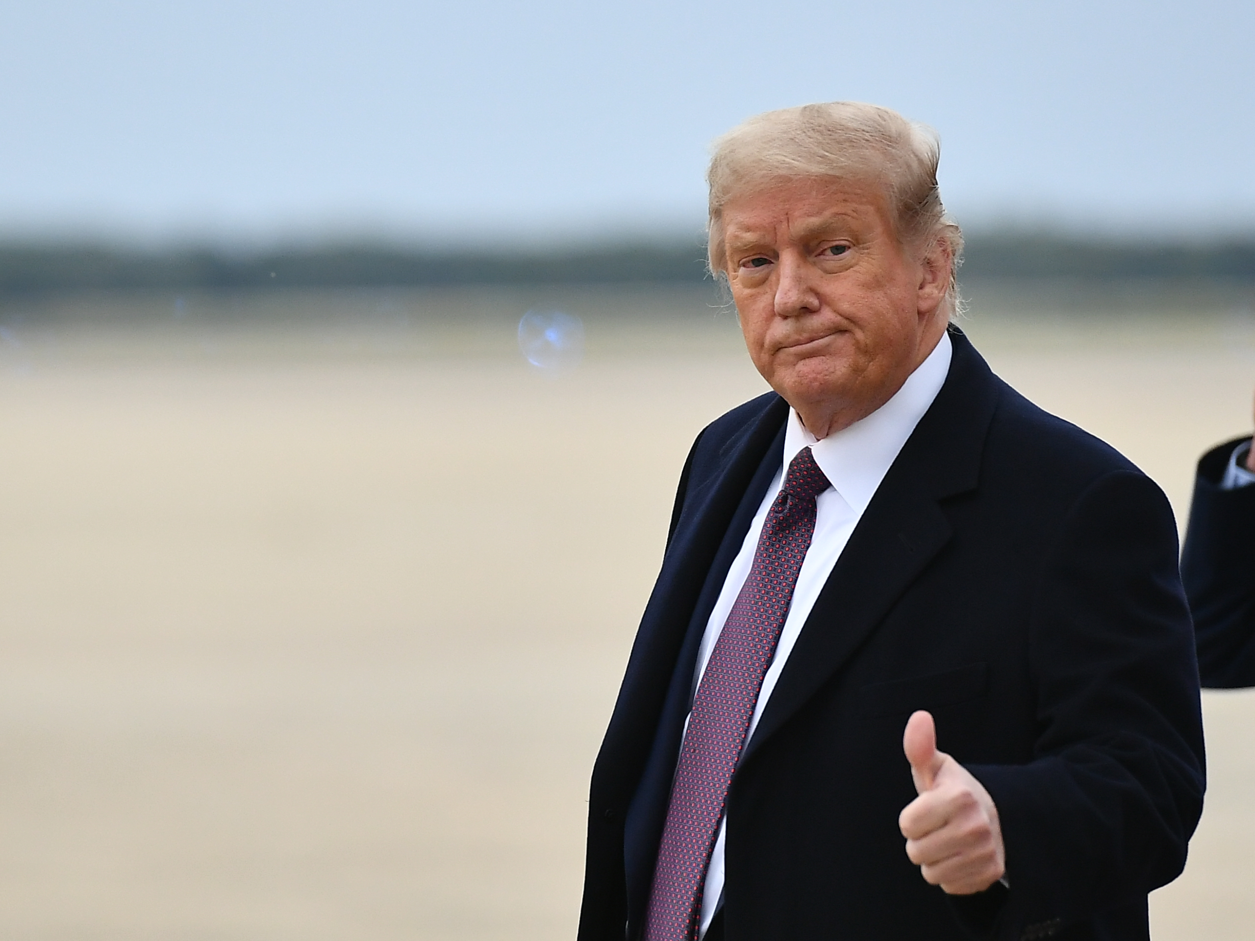 President Donald Trump gives a thumbs up as he steps off Air Force One upon arrival at Andrews Air Force Base in Maryland on October 1, 2020. (Mandel Ngan/AFP via Getty Images)