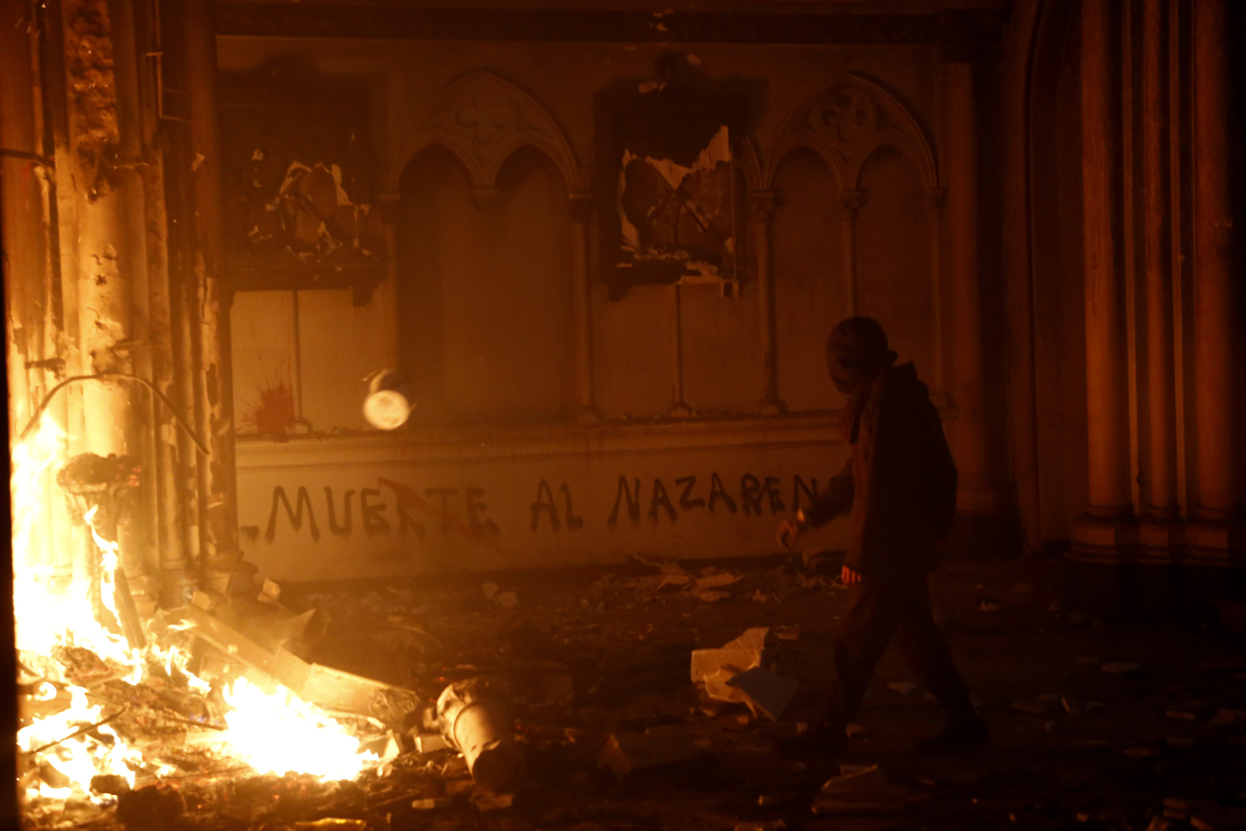 Masked men burn down a Carabineros church during a protest on October 18, 2020 in Santiago, Chile. (Marcelo Hernandez/Getty Images)